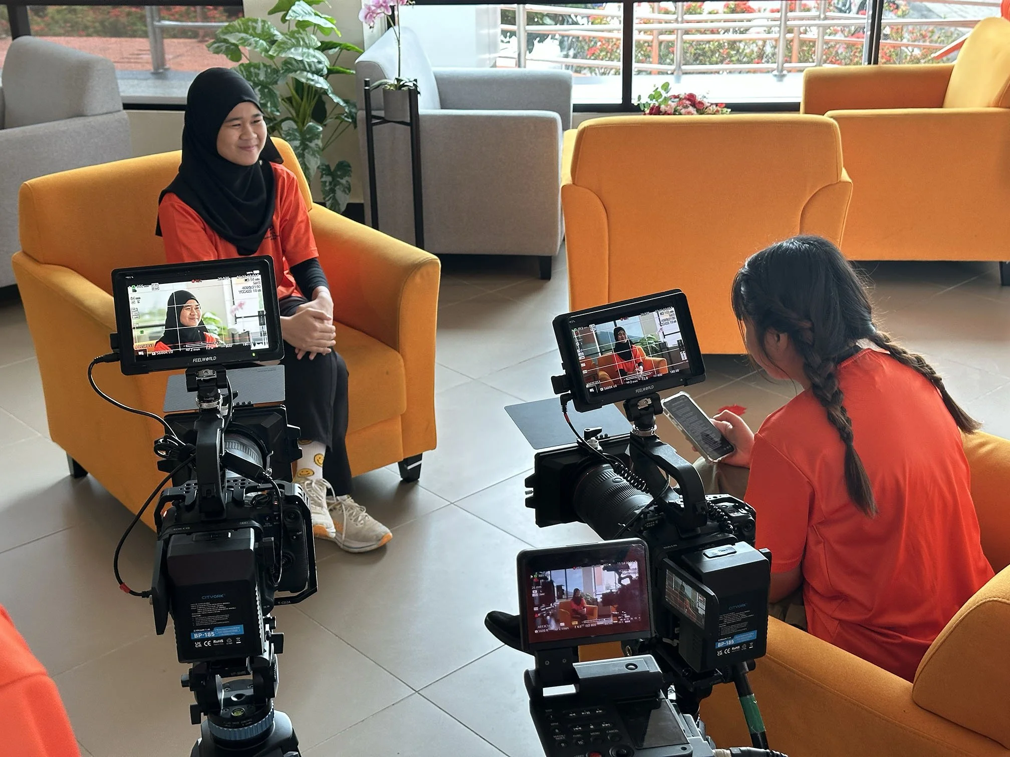CENTEXS Lundu students conducting a corporate interview exercise using professional video cameras during hands-on production training