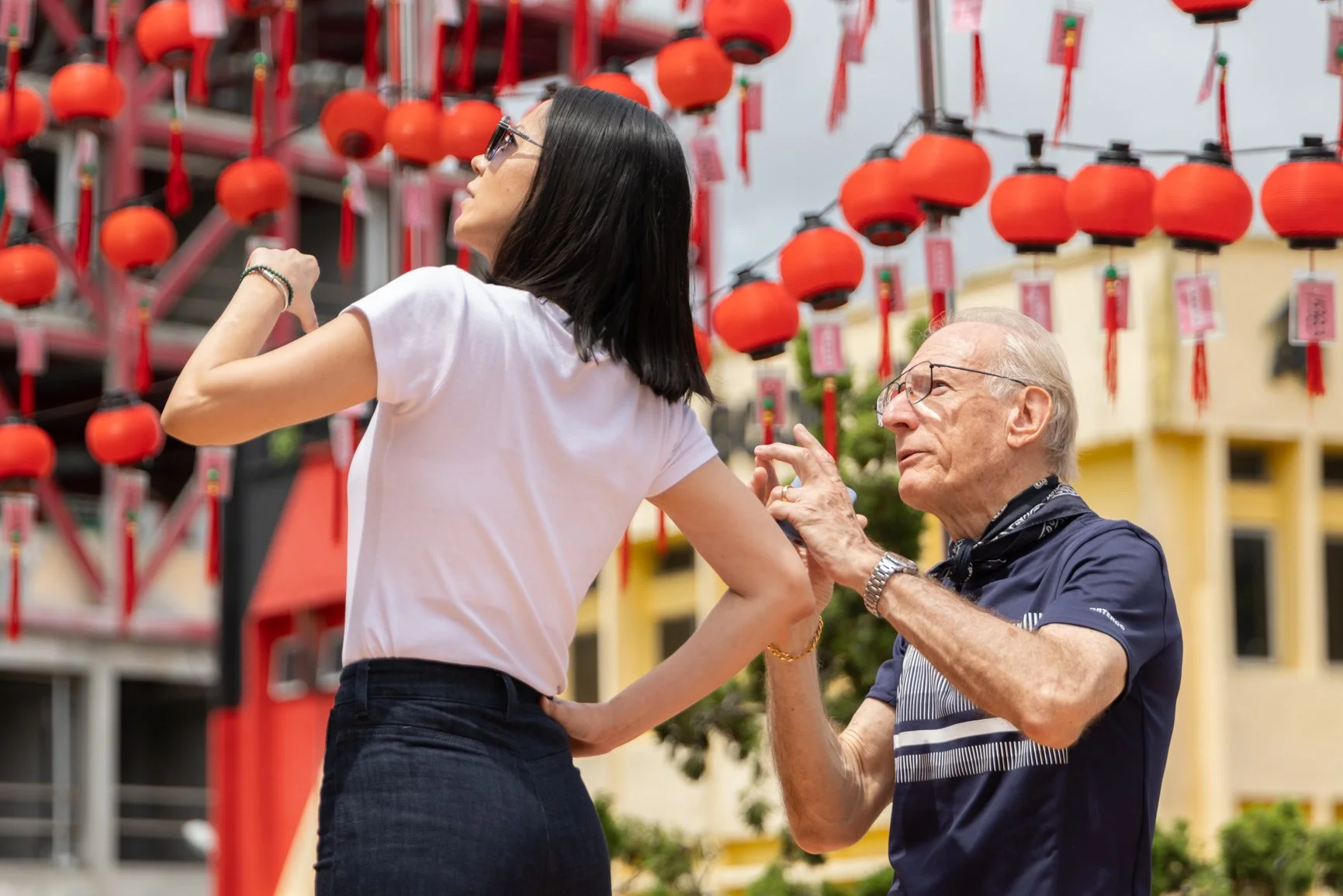 Behind the scenes of a Sarawak Tourism Board commercial shoot with talents interacting under traditional Chinese lantern decorations