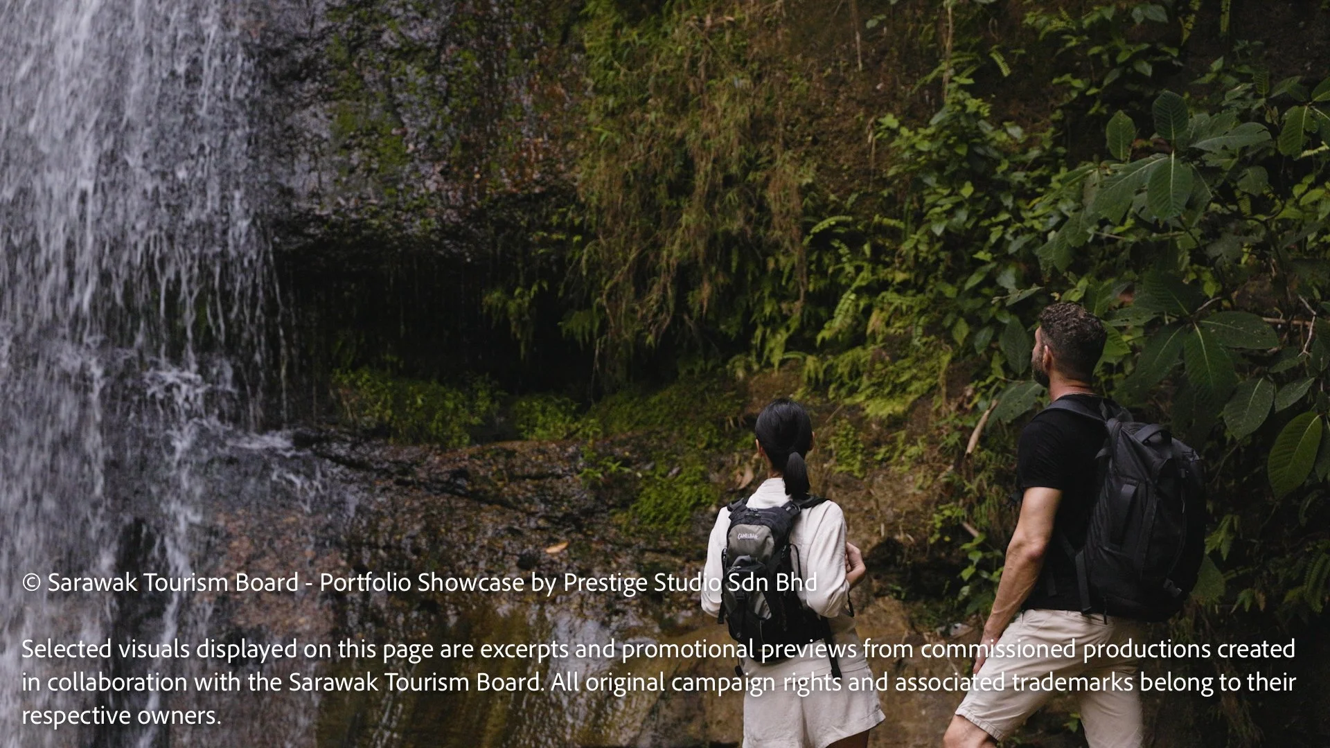 Travellers discovering a hidden rainforest waterfall in Sarawak, Borneo during the Gateway to Borneo tourism documentary campaign.