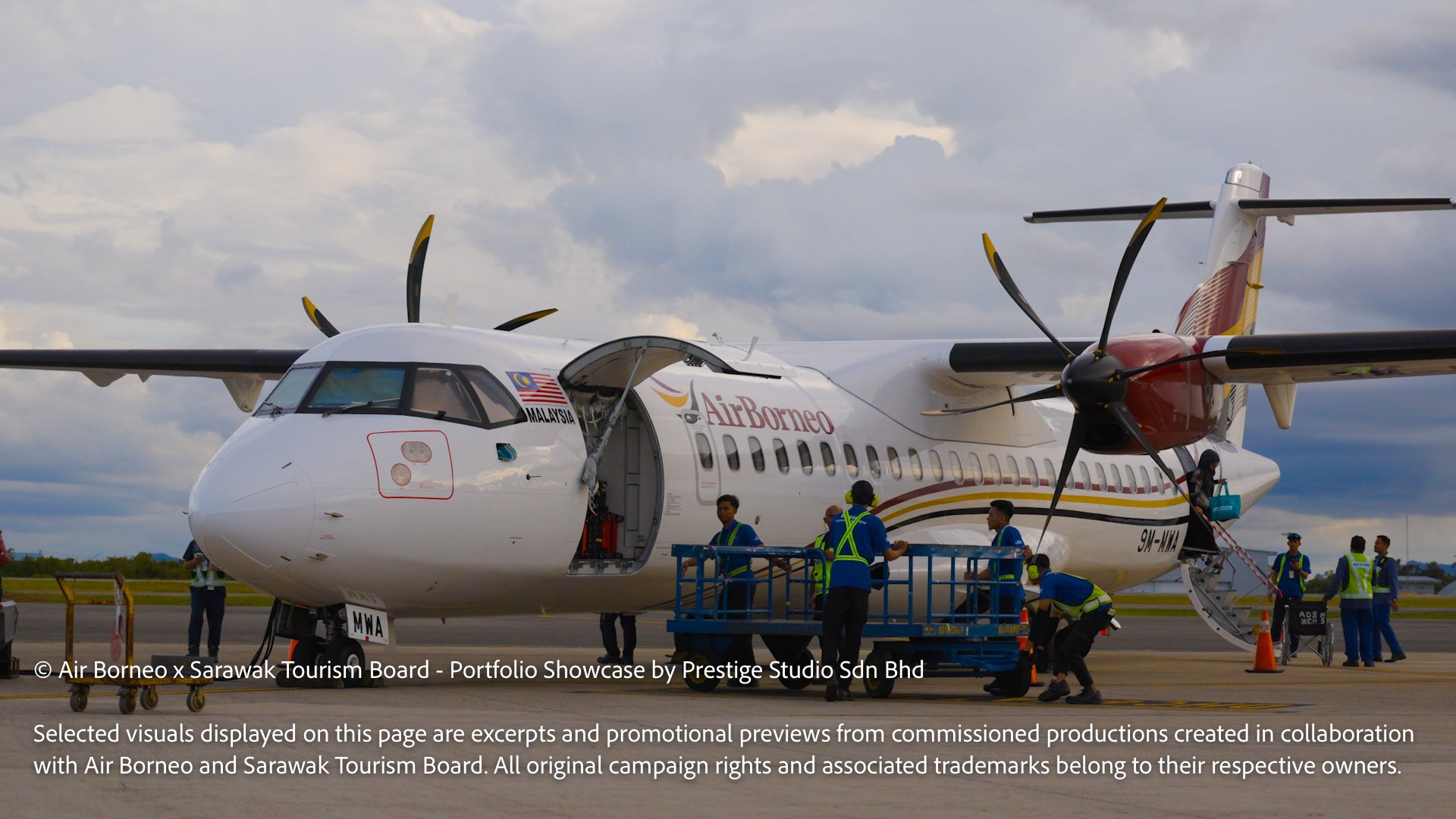 Air Borneo aircraft parked on the tarmac with ground crew handling airport operations