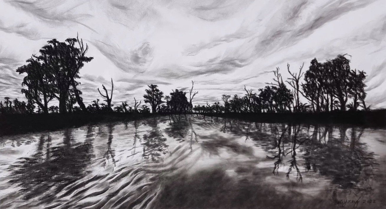 Black and white photograph of a landscape with water in the foreground and trees and cloudy sky in the background.