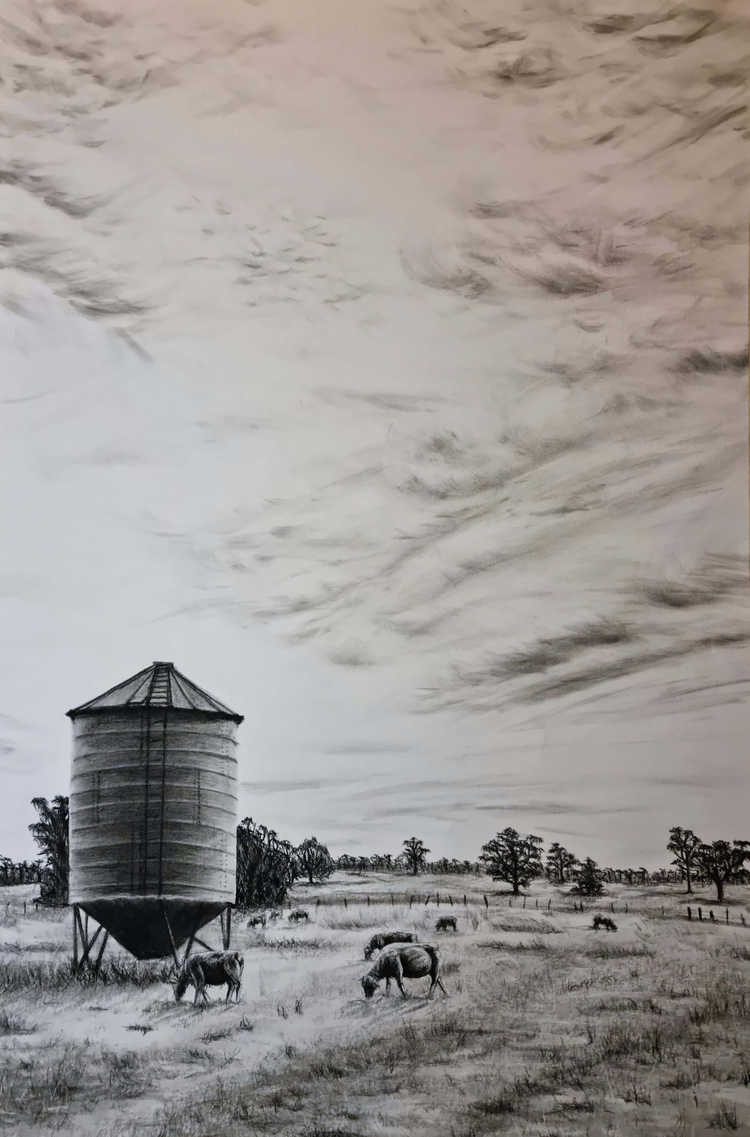 A black and white drawing of a rural landscape with a large silo, grazing cows, trees, and a cloudy sky.