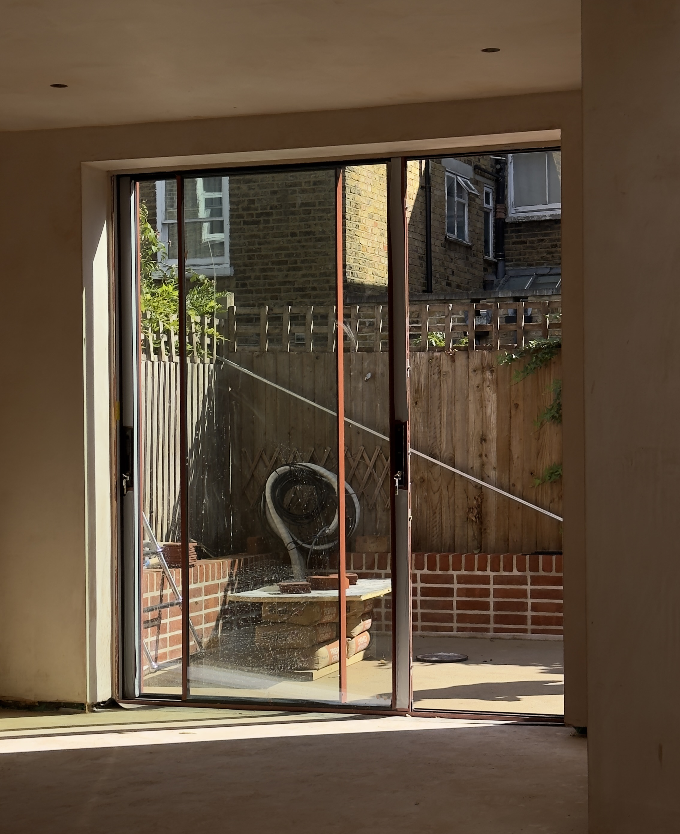 Glazed opening connecting a renovated London home with the rear garden.