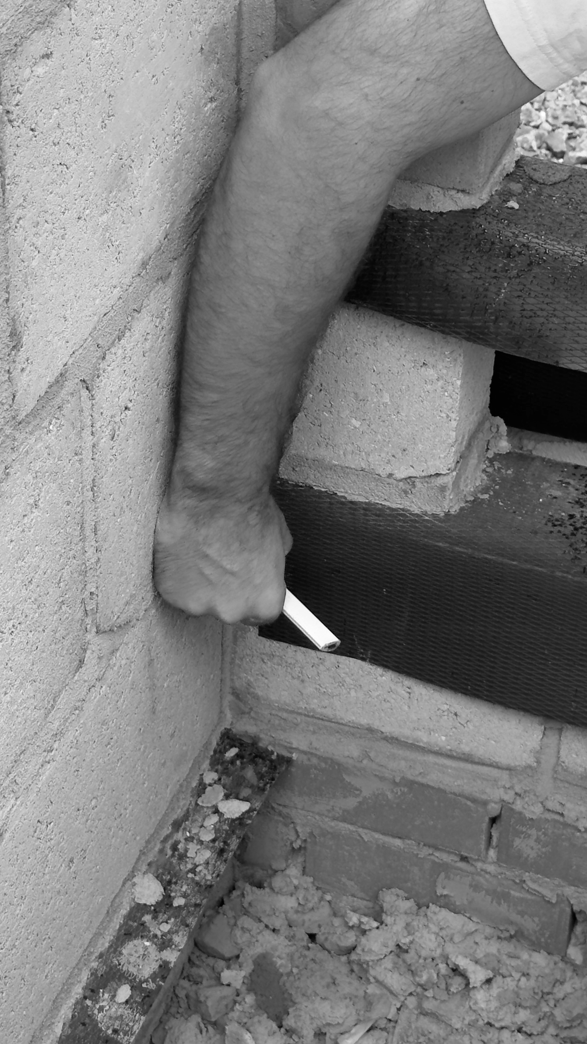 Irakli Iremadze, co-founder of Arcade London Group, inspecting a masonry detail during a residential renovation.