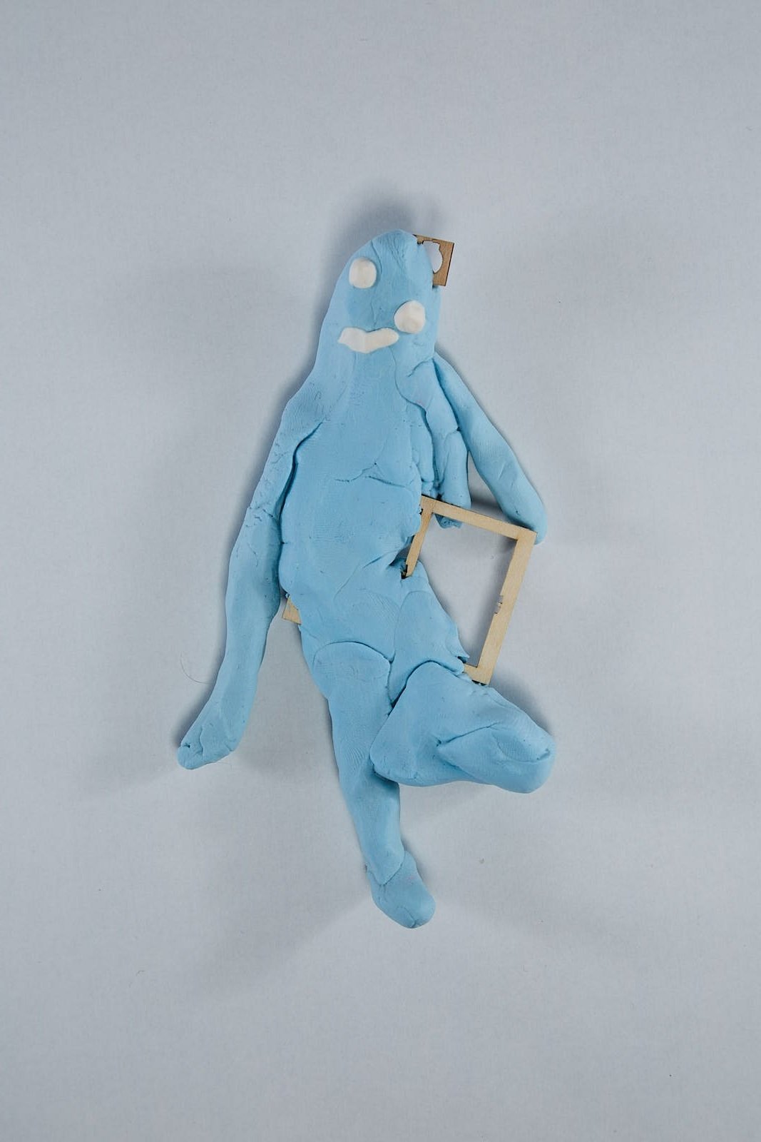 'I'm a window frame' from "Under the weight of societal expectations" series, 2021. Soft polymer clay and dolls accessories - 15 x 10 x 2 cm