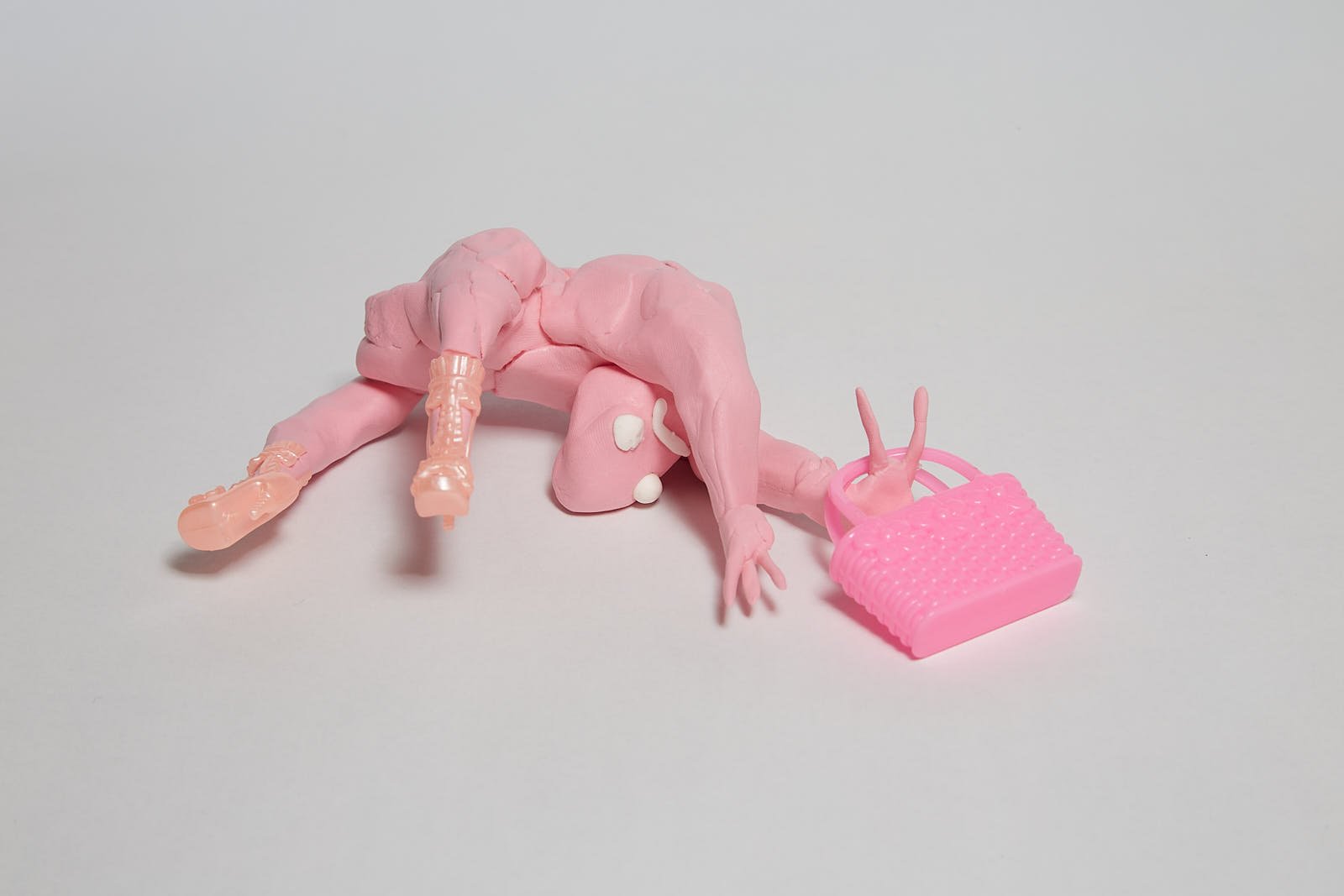 'Getting that bag' from "Under the weight of societal expectations" series, 2021. Soft polymer clay and dolls accessories - 10 x 14 x 5 cm