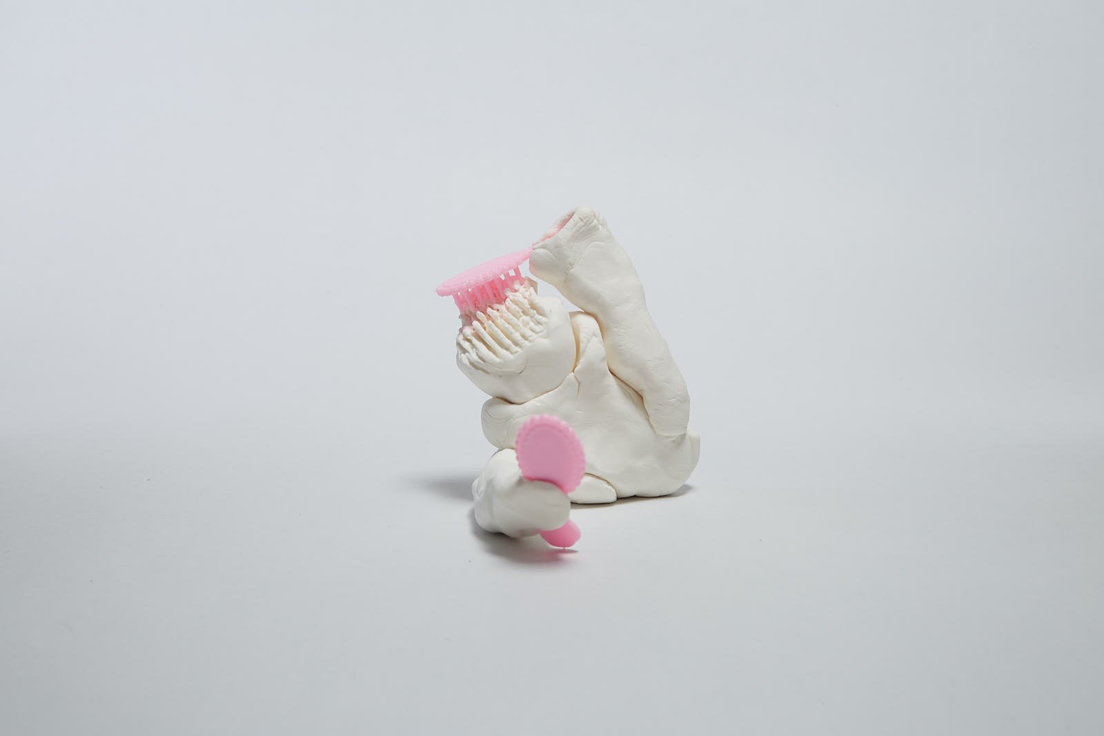 'Artist must be beautiful' from "Under the weight of societal expectations" series, 2021. Soft polymer clay and dolls accessories - 9 x 9 x 10 cm