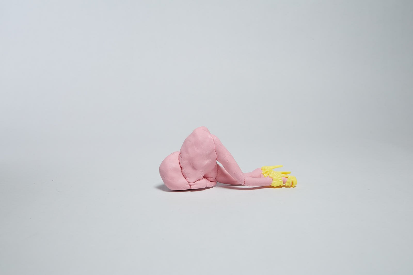 'Collapse' from "Under the weight of societal expectations" series, 2021. Soft polymer clay and dolls accessories - 12 x 5 x 4 cm