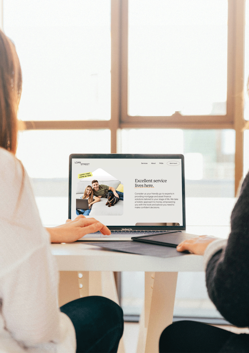 Reviewing trust loan options together on a laptop