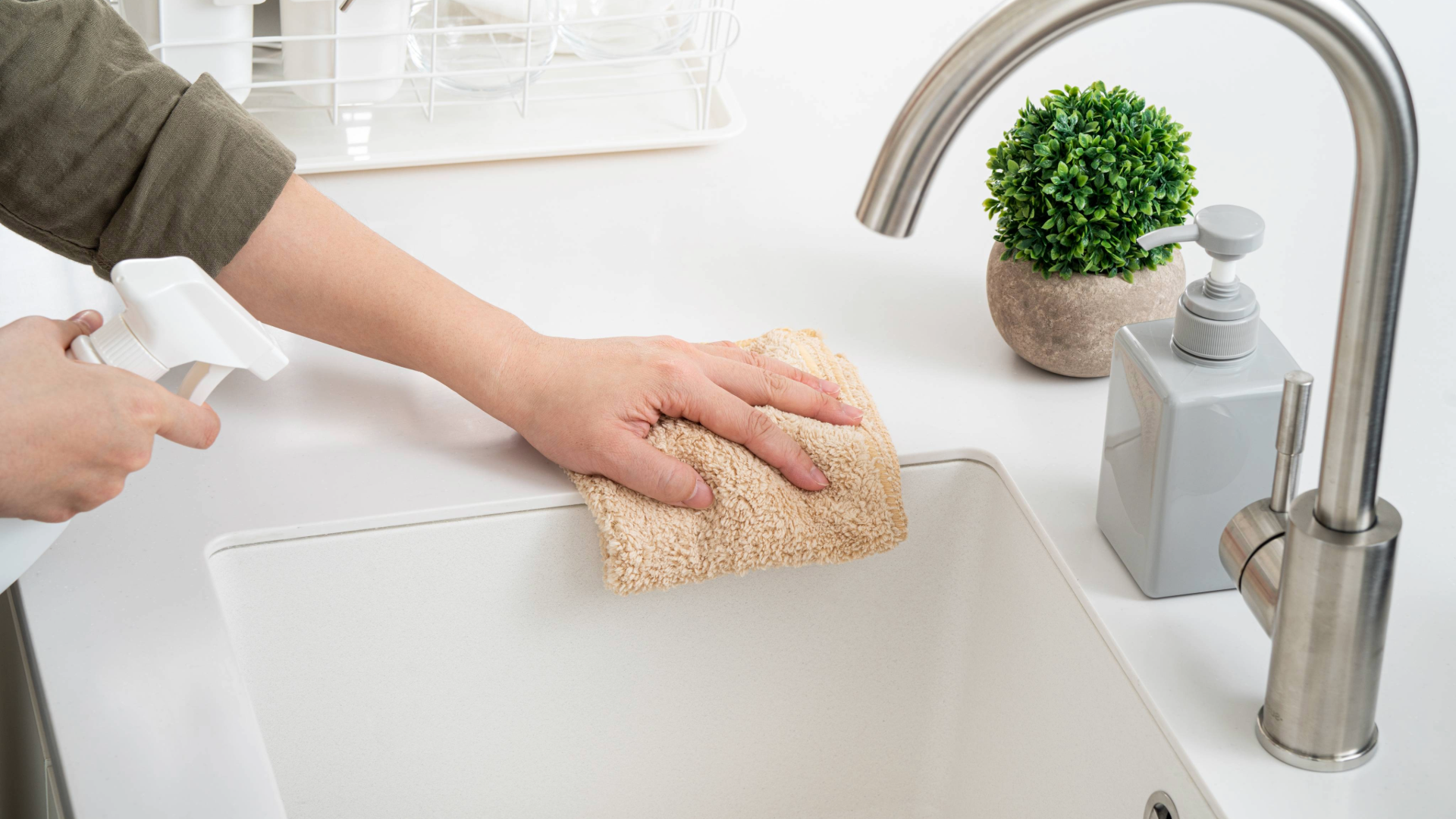 Woman cleaning kitchen counters as part of a Spring cleaning project in the kitchen