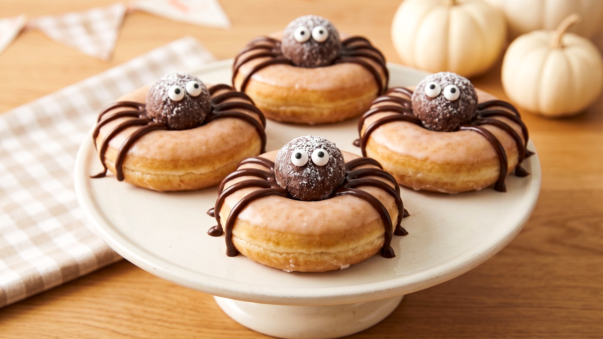 Store-bought donuts and donut holes decorated to look like fun, spooky Halloween spider desserts.
