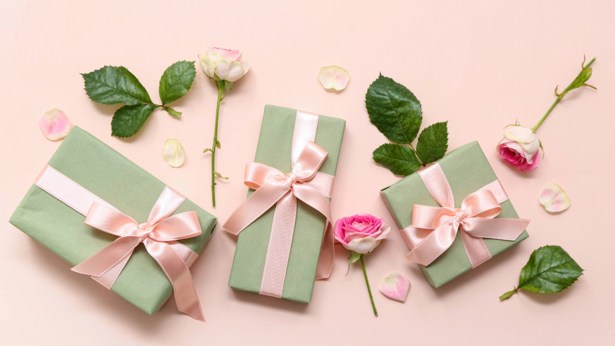 Galentine’s Day gifts for friends flat lay with wrapped presents and flowers
