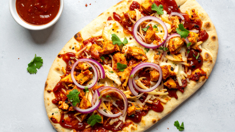 BBQ chicken naan pizza with red onions and cheese