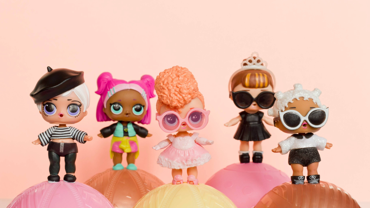 L.O.L. Surprise dolls on top of mini containers for a child's toy collection