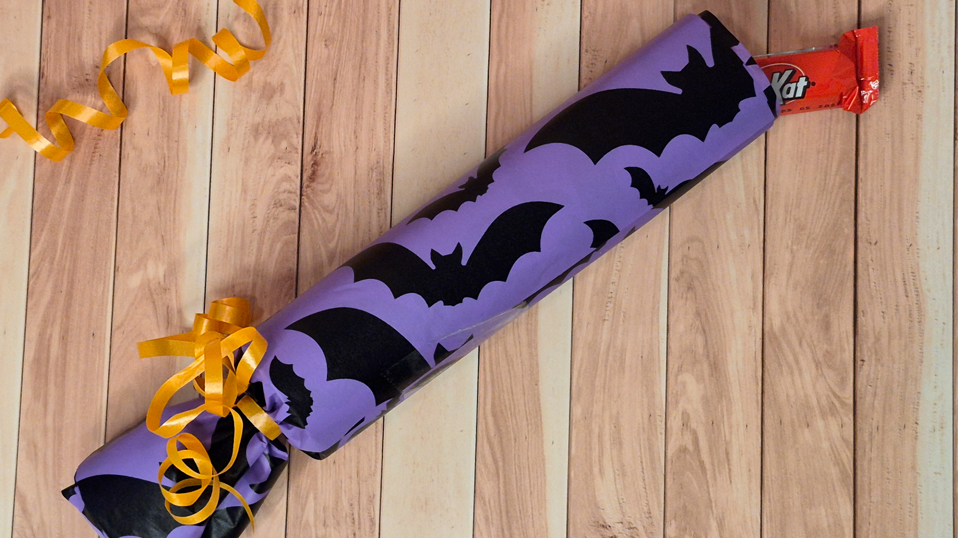 Almost-completed Halloween favor cracker being filled with candy.