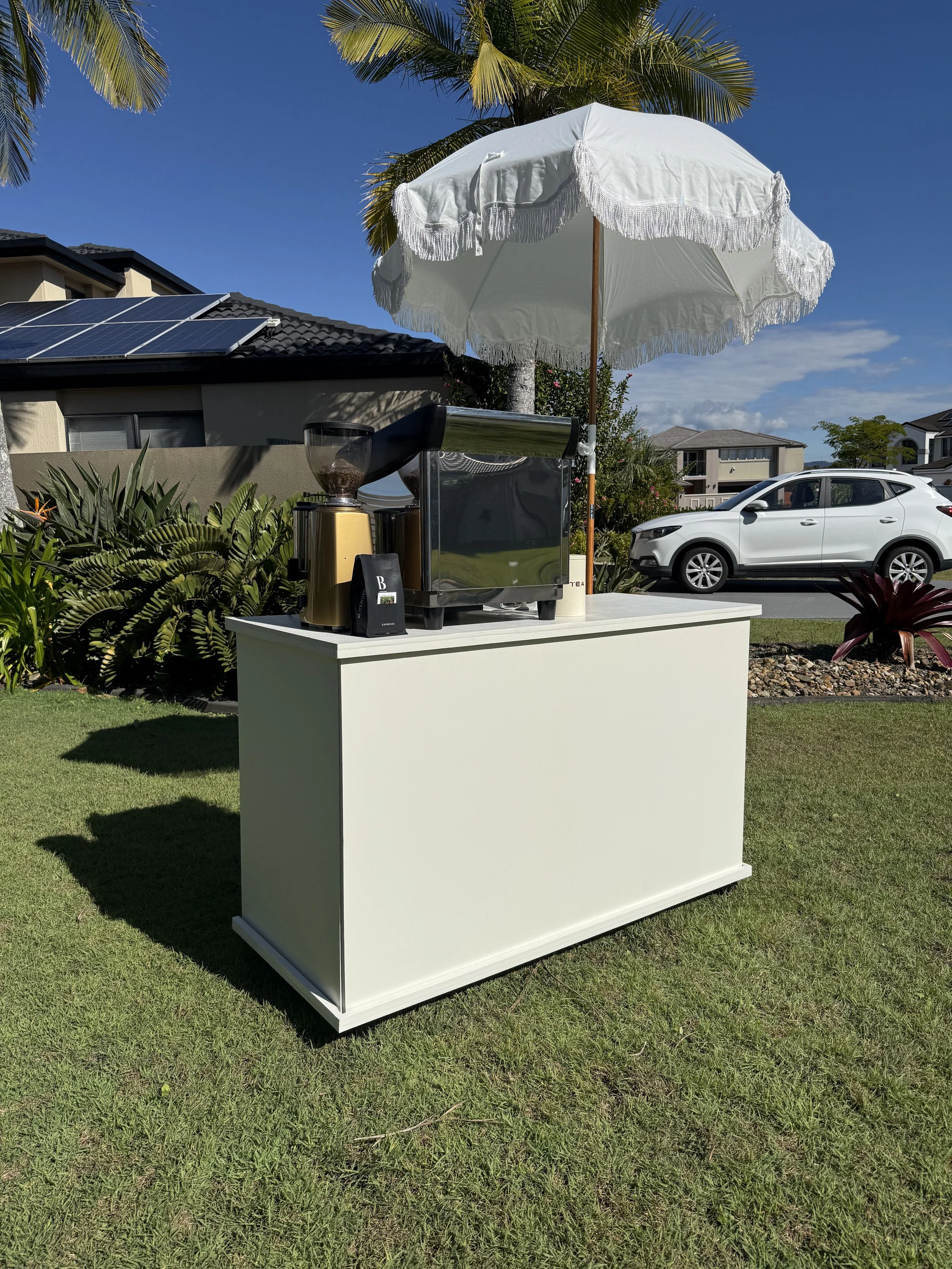 a customisable coffee cart for events, with umbrella, coffee machine and grinder