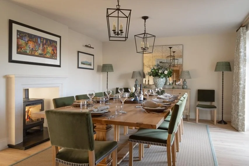 From the early construction phases to the final styling of this room, every detail was chosen to create a sense of timeless allure. 

The room is anchored by a stunning bespoke oak table, paired with rich green velvet seating and striking lighting to