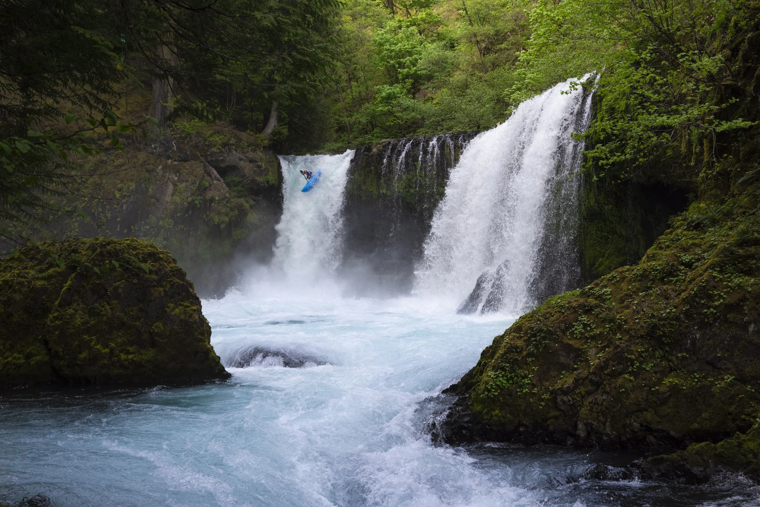 A kayaker descends a 30 foot cascading waterfall in the Columbia River Gorge of Washington State.
