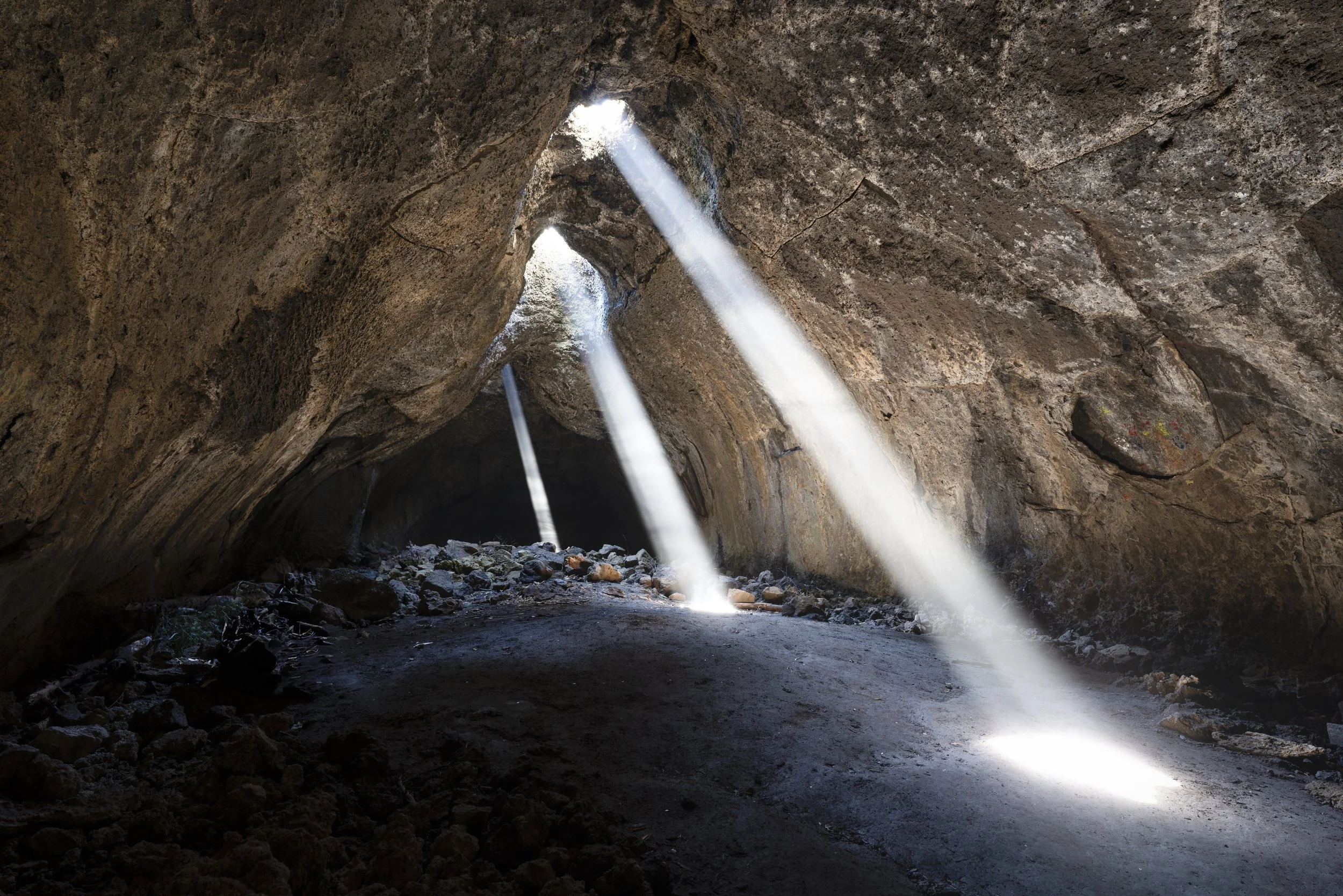 Late morning light beams through the ceiling of these hidden lava tube caves.