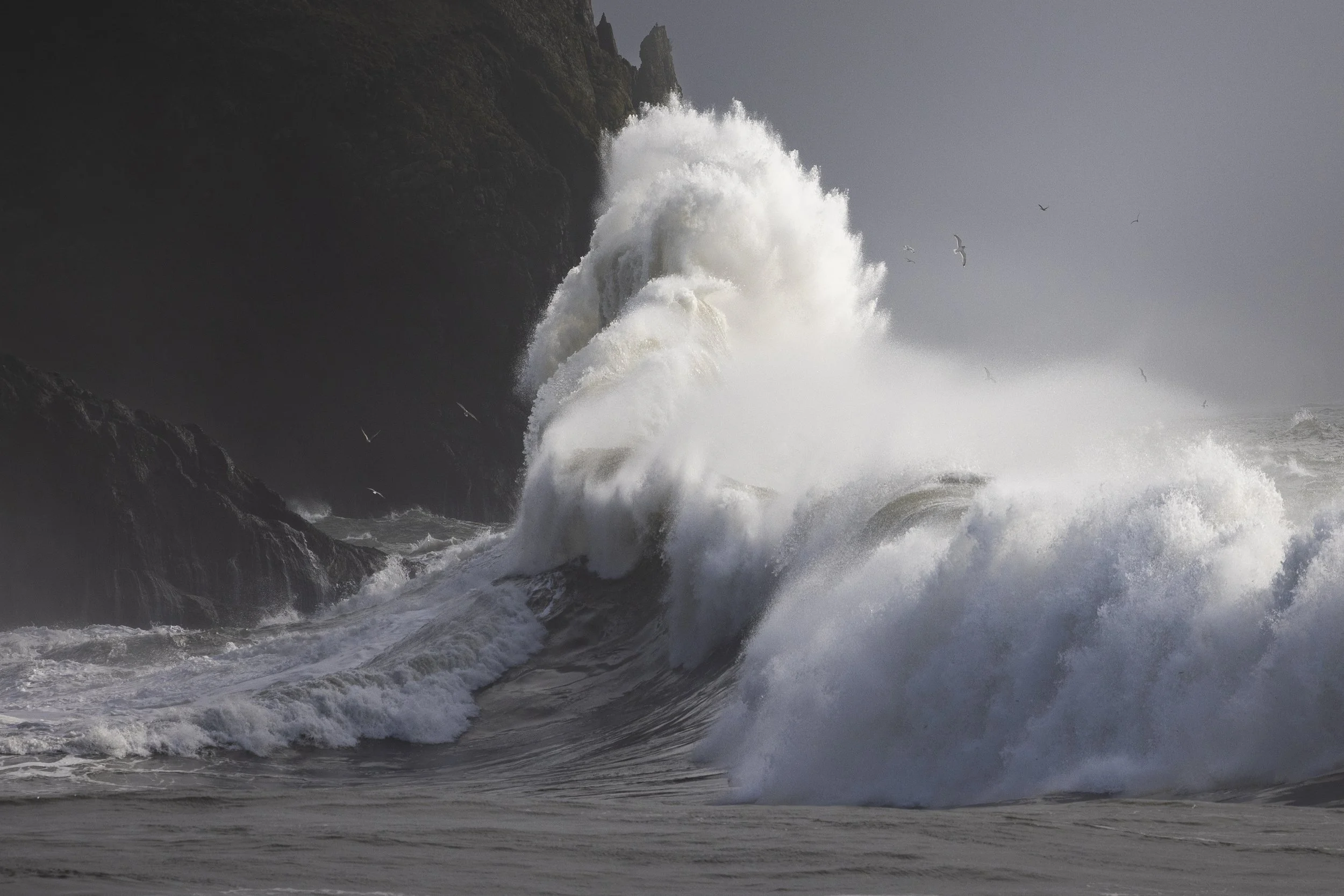 A series of waves crash into one another during the king tides at Cape Disappointment State Park in Washington State.