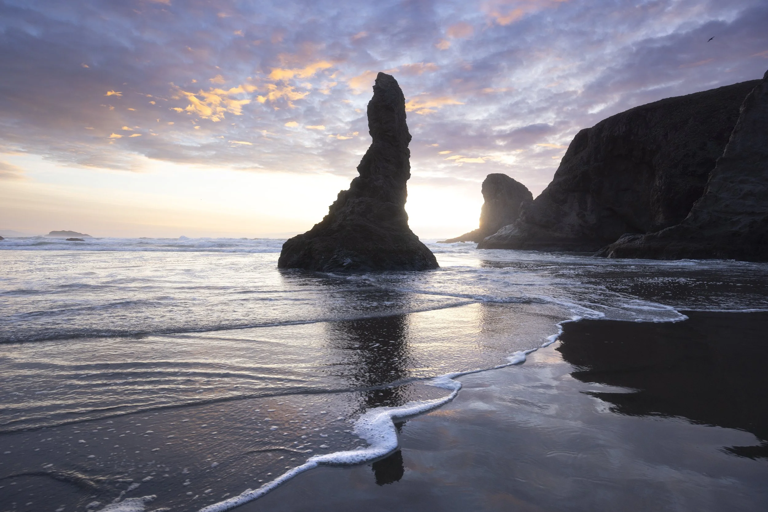 A colorful sunset over the sea stacks of Bandon Beach on the Oregon coast.