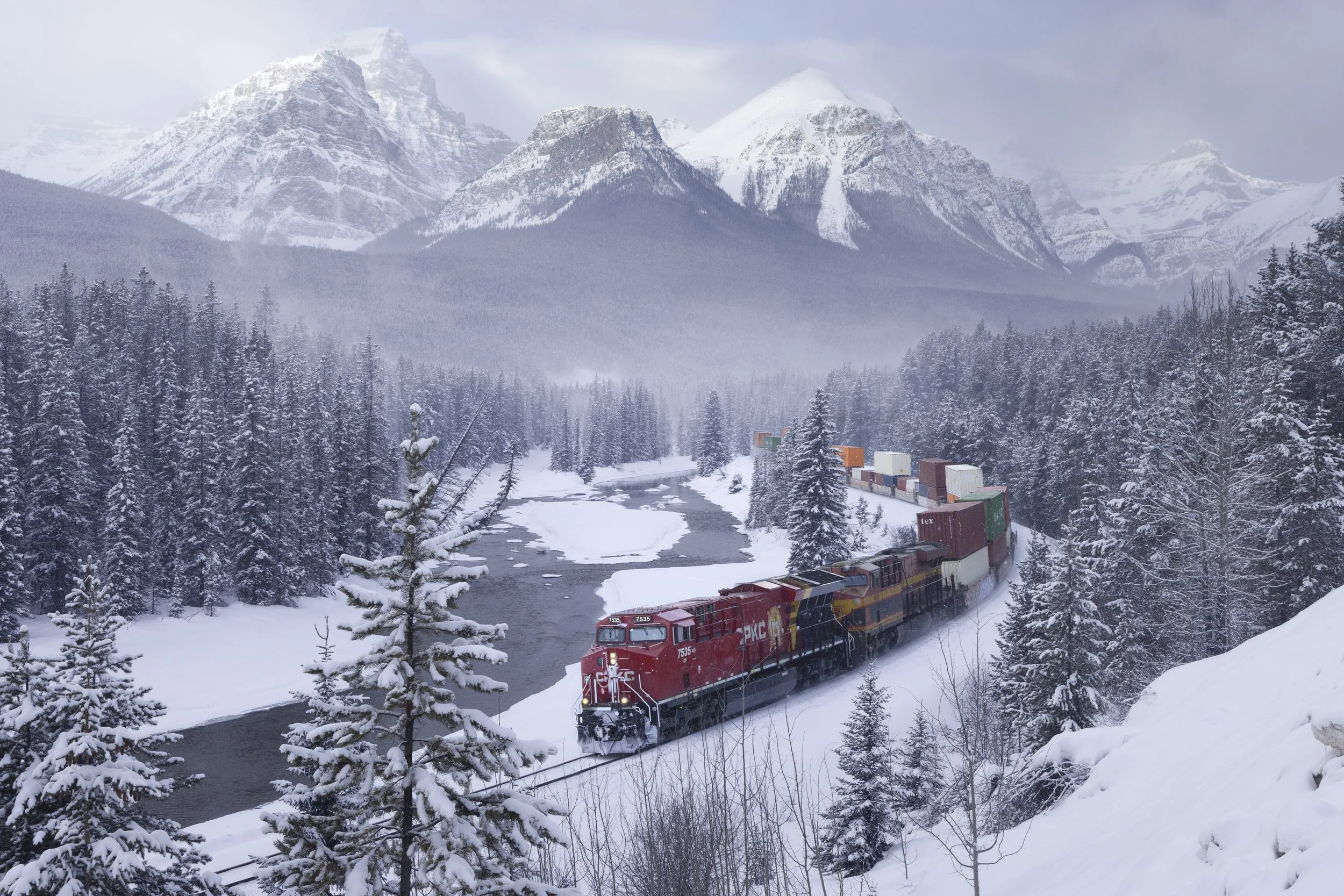 The canadian pacific train cuts through the heart of Banff National Park in Alberta Canada.