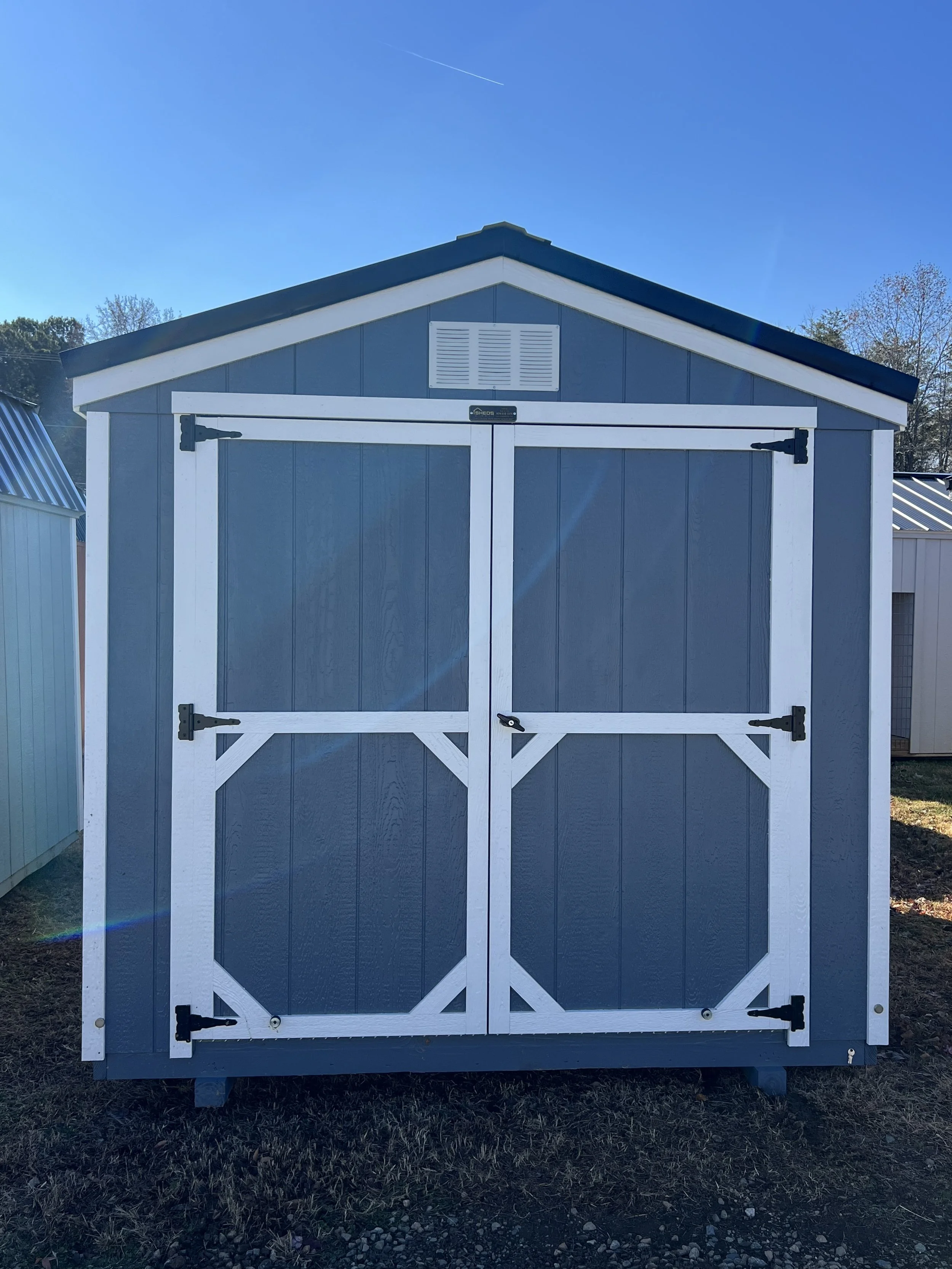 Belmont Blue and white storage shed with windows under construction indoors