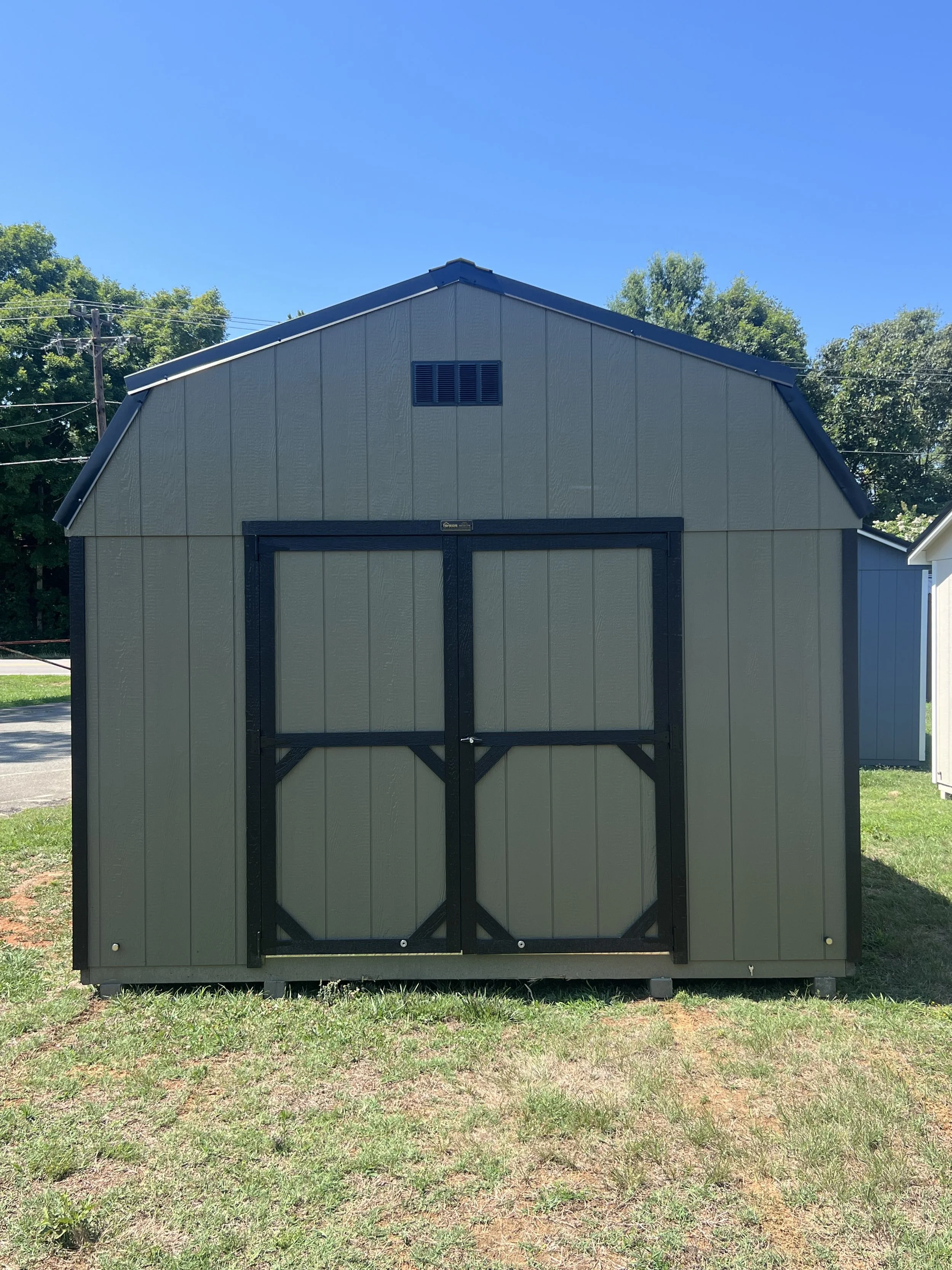 An avocado barn with back trim and metal roof 