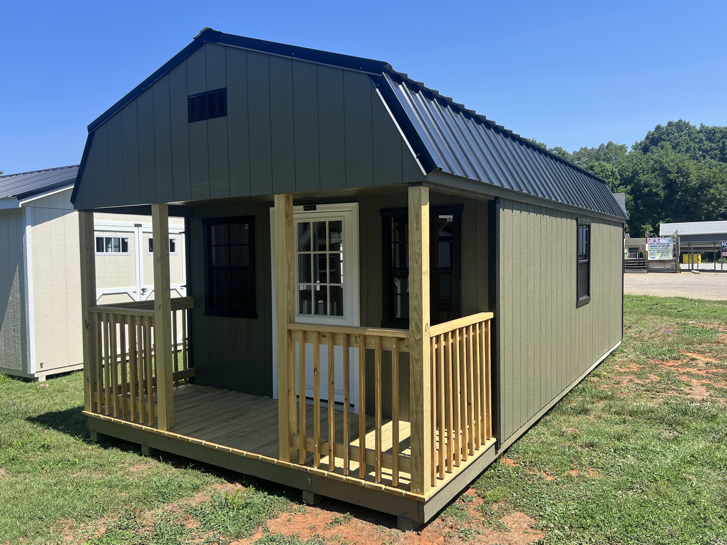 Portable red shed with metal roof and double doors