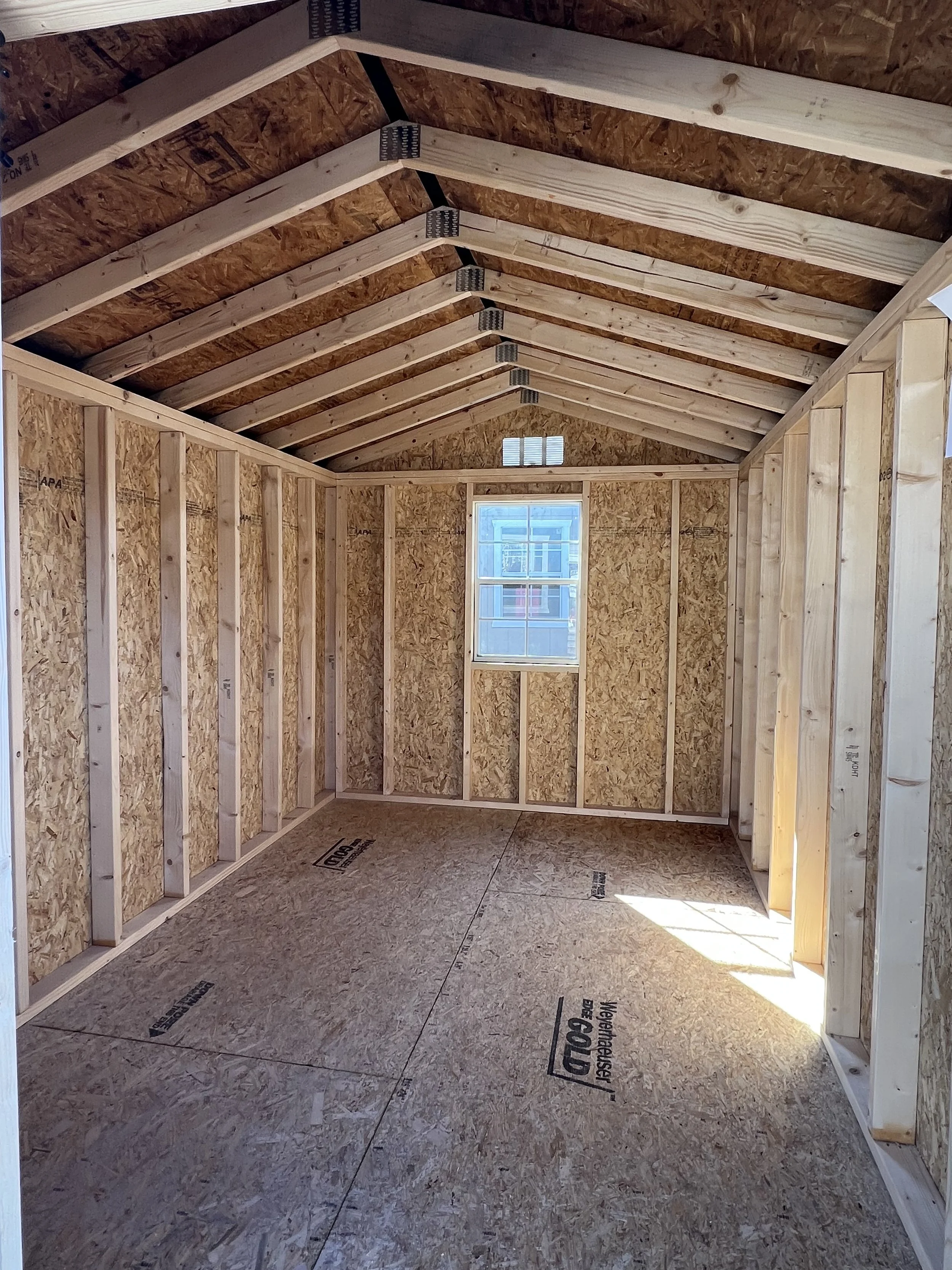 Belmont Blue with black trim and a black metal roof inside a warehouse.