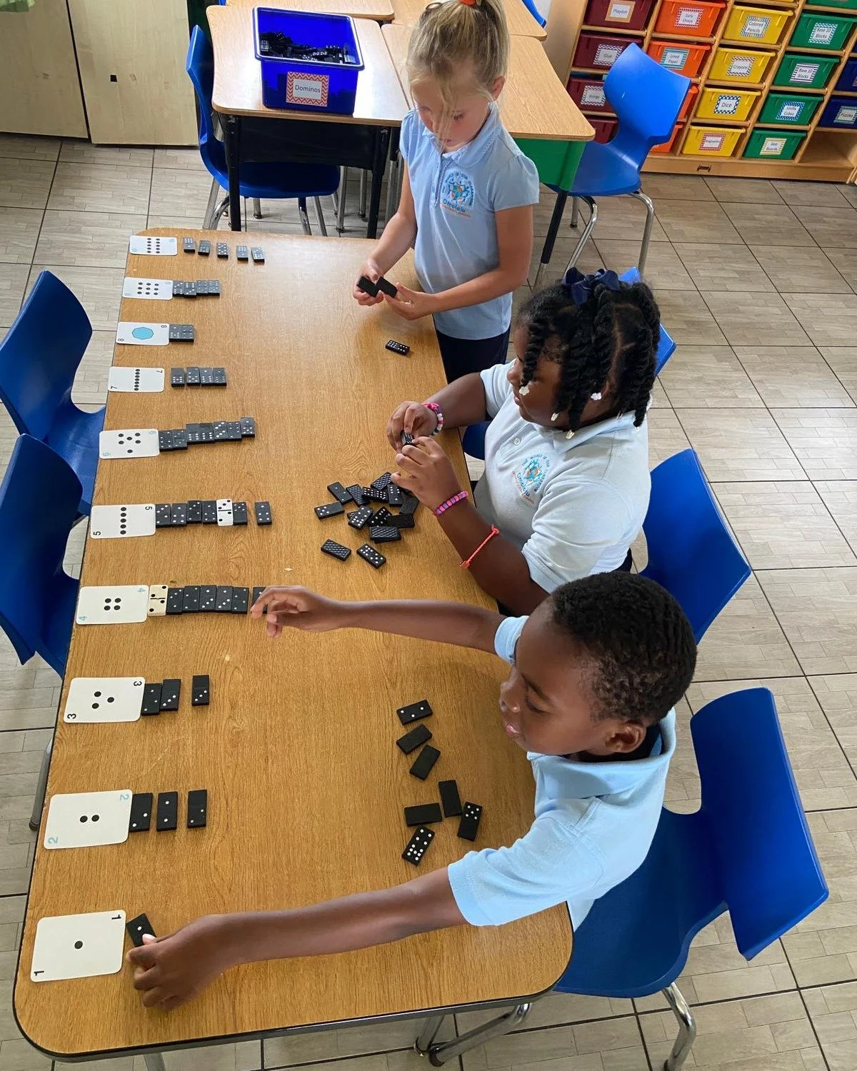 Let's check in with Grade 2: here they are engaging in math in action using &quot;Everyday Math&quot; to find numerical equivalencies with dominoes.