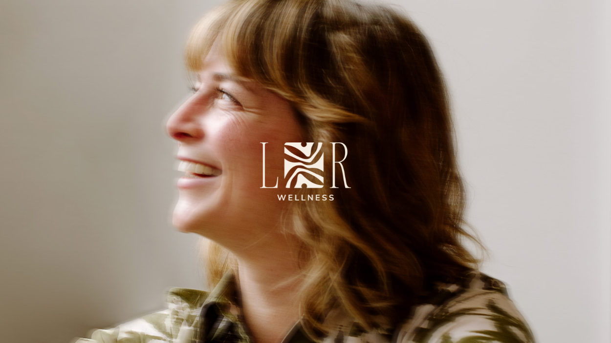 Banner image of a woman smiling with blurred effect and LR Wellness logo layered over the top with soulful and earthy icon work