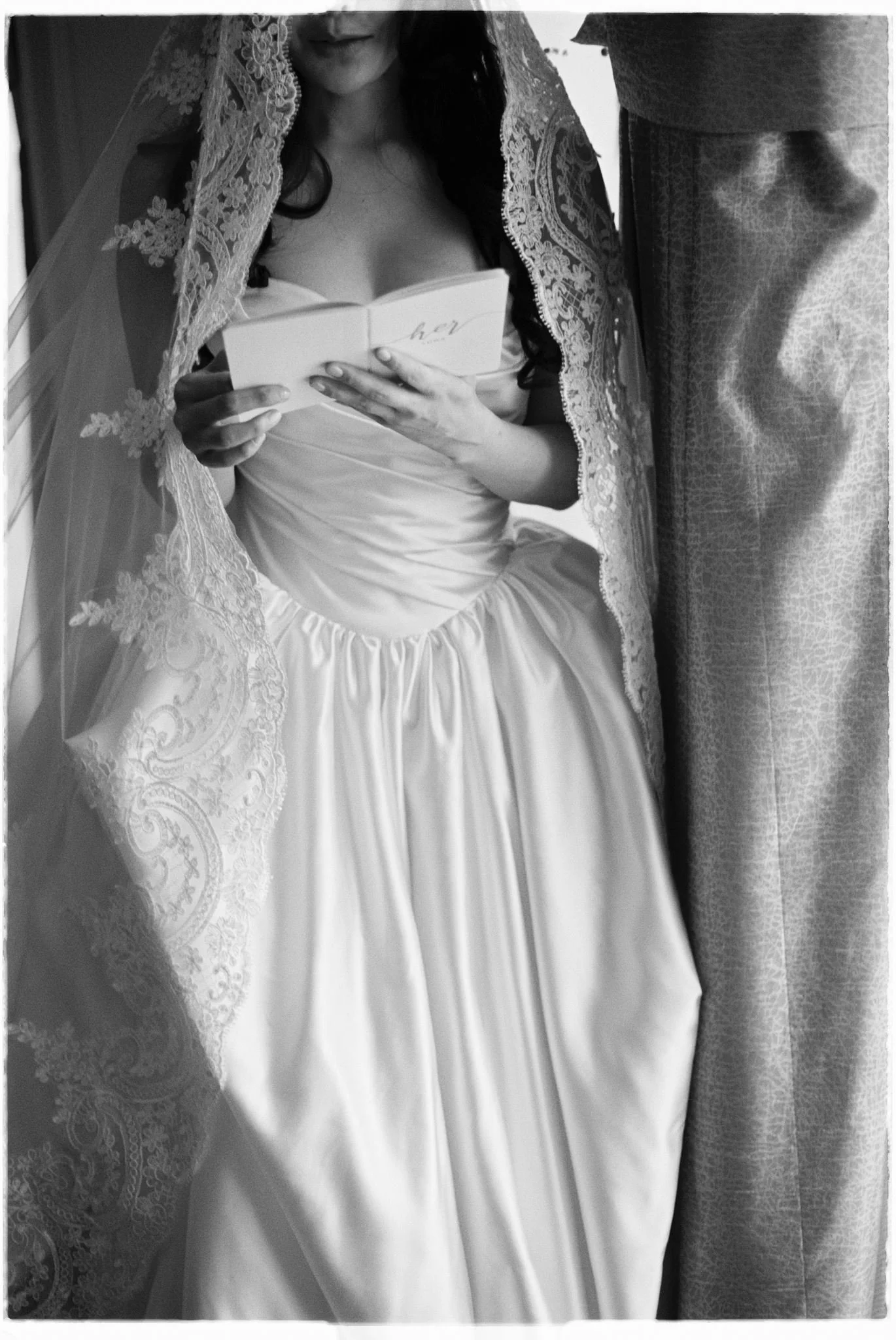 bride reading her vows beside a window