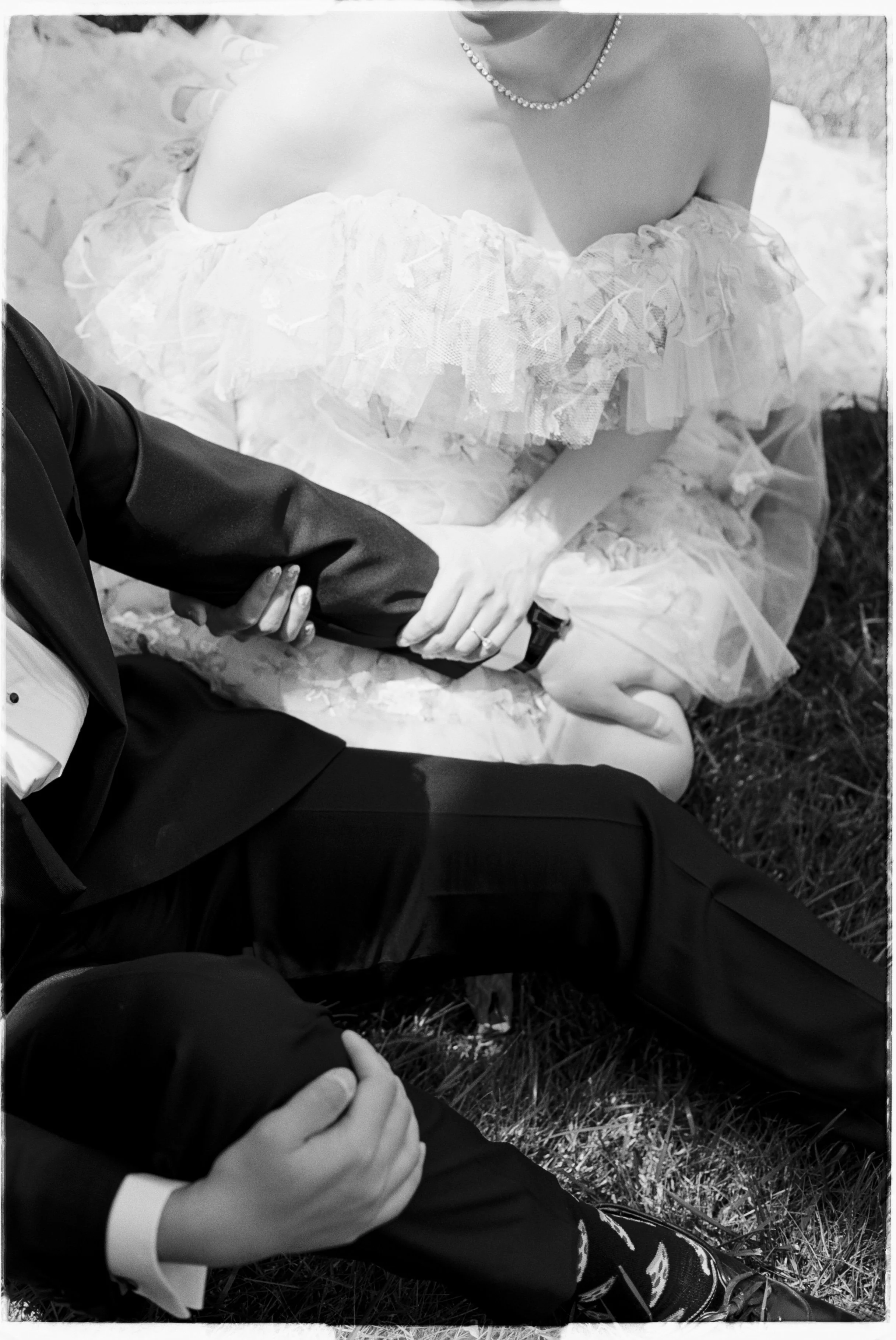 couple sitting in grass on their wedding day in the fraser valley