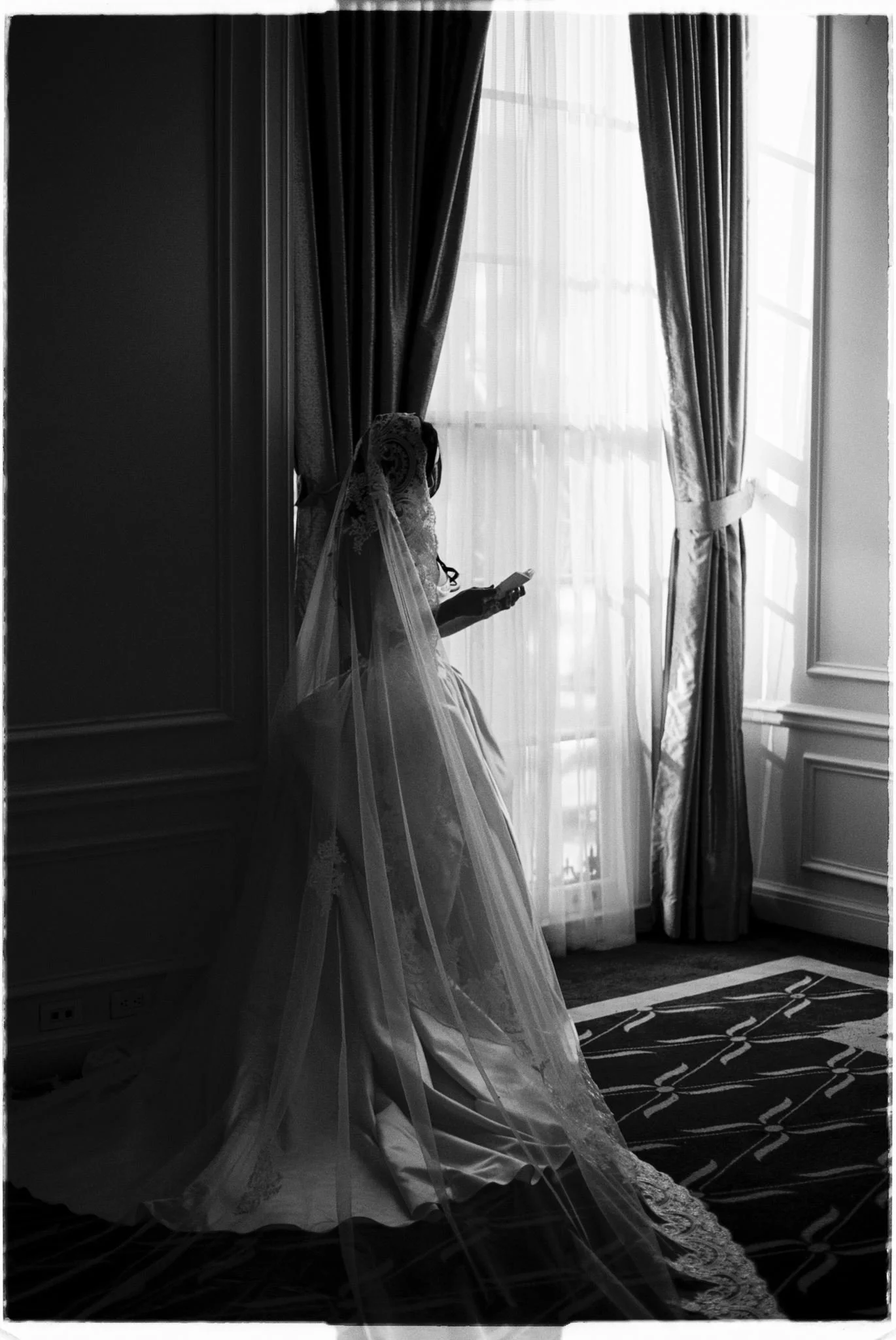 bride reading her vows beside a window