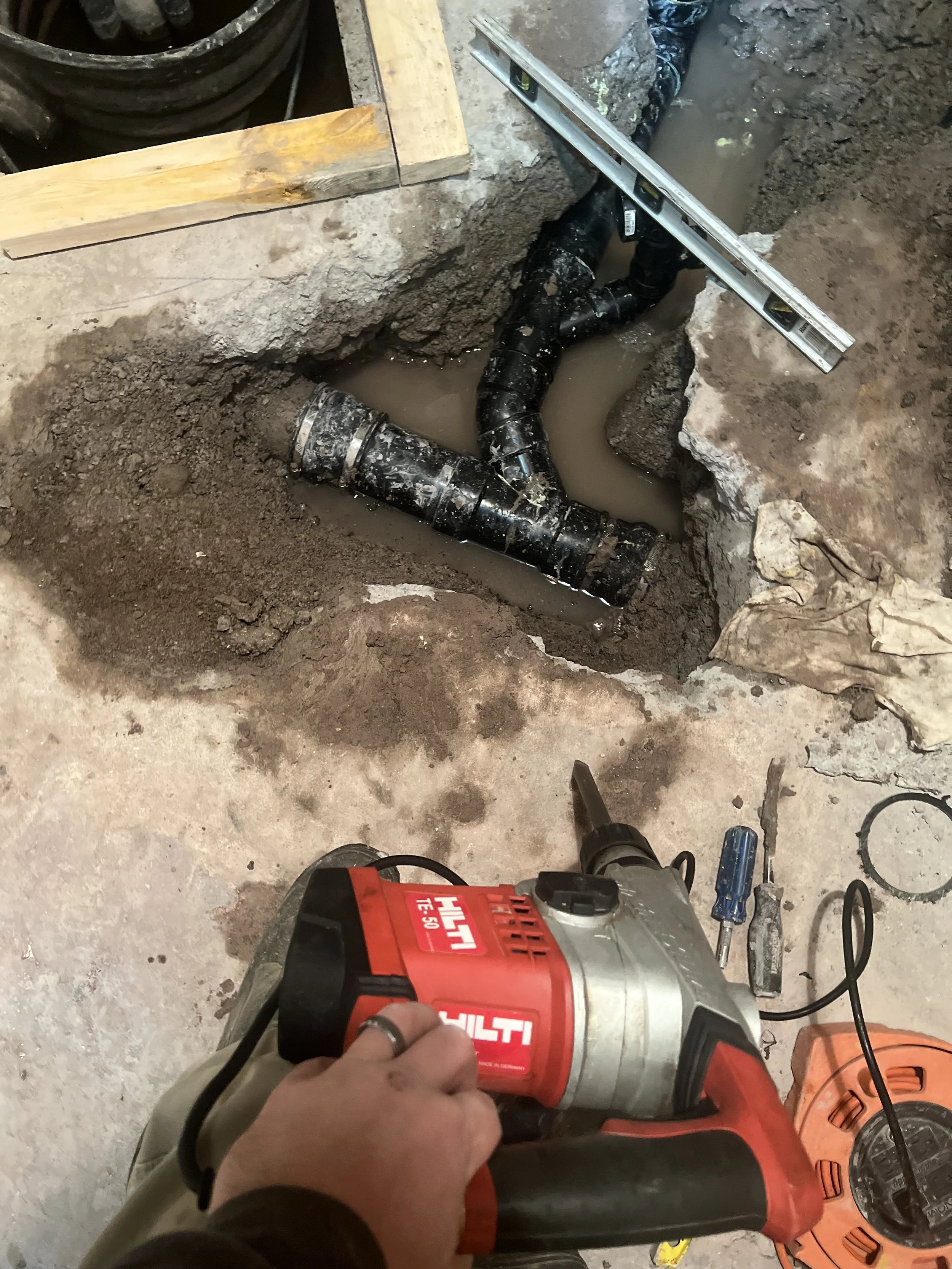 Repairing a leaking drain system under cement
