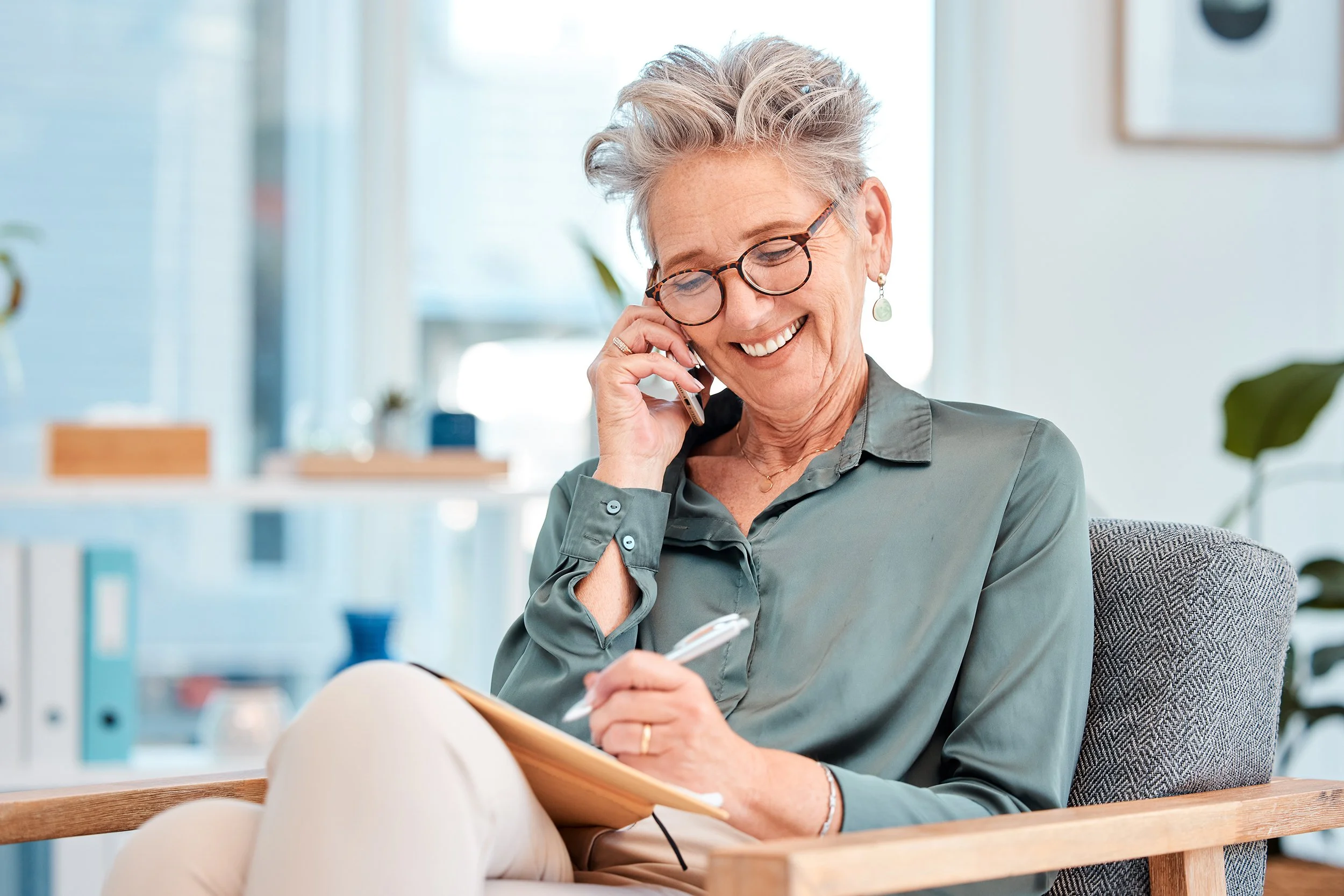 An older businesswoman talks on the phone. Apple employees 50+ can contribute an extra $8,000 to their 401(k) in 2026. Learn about super catch-up for ages 60-63 and mandatory Roth rules for high earners.