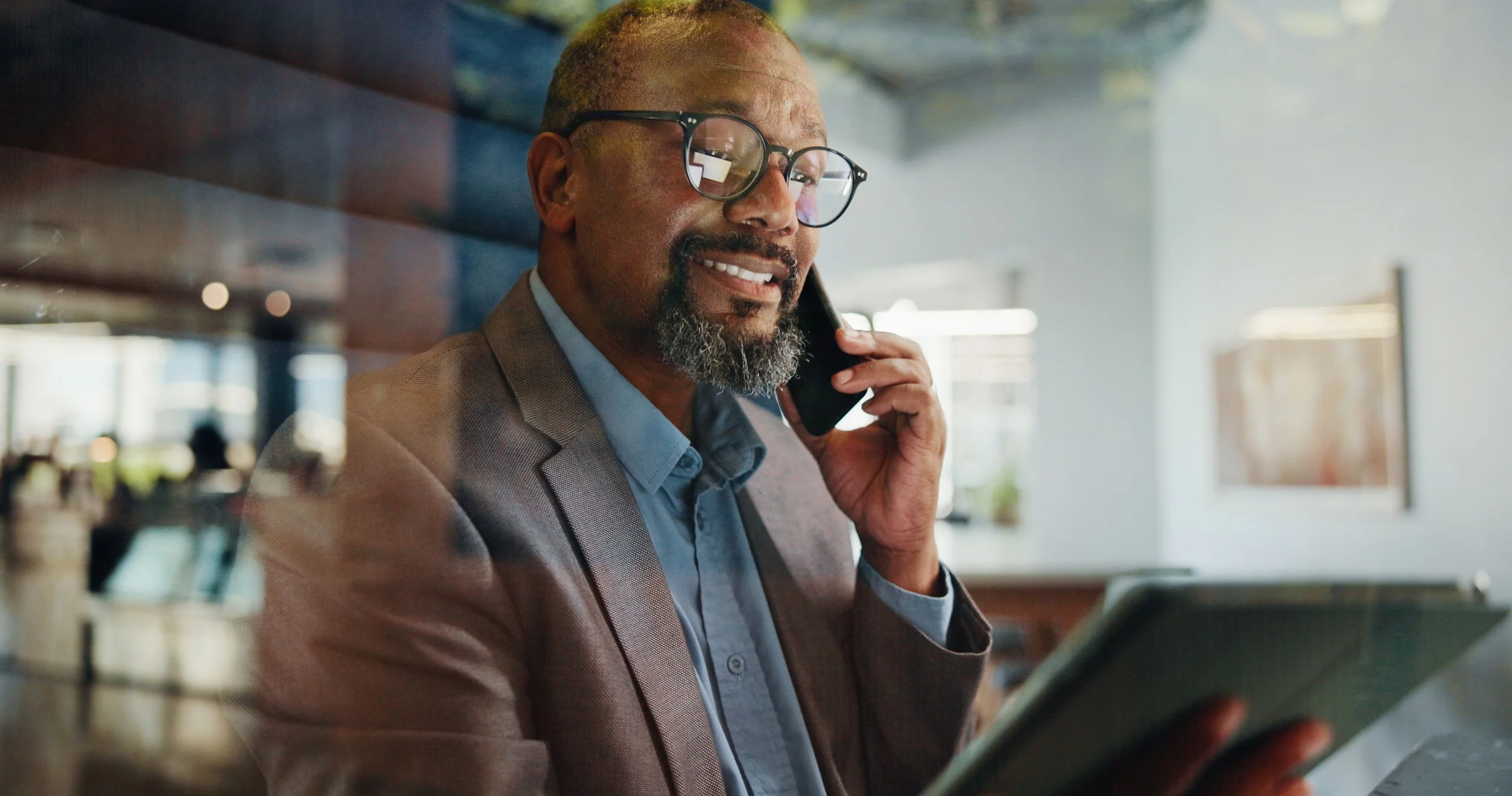Man at desk on cell phone. Learn how Cisco's trading window policy works, who qualifies as an Insider, and what rules apply during blackout periods — before you make a costly mistake.