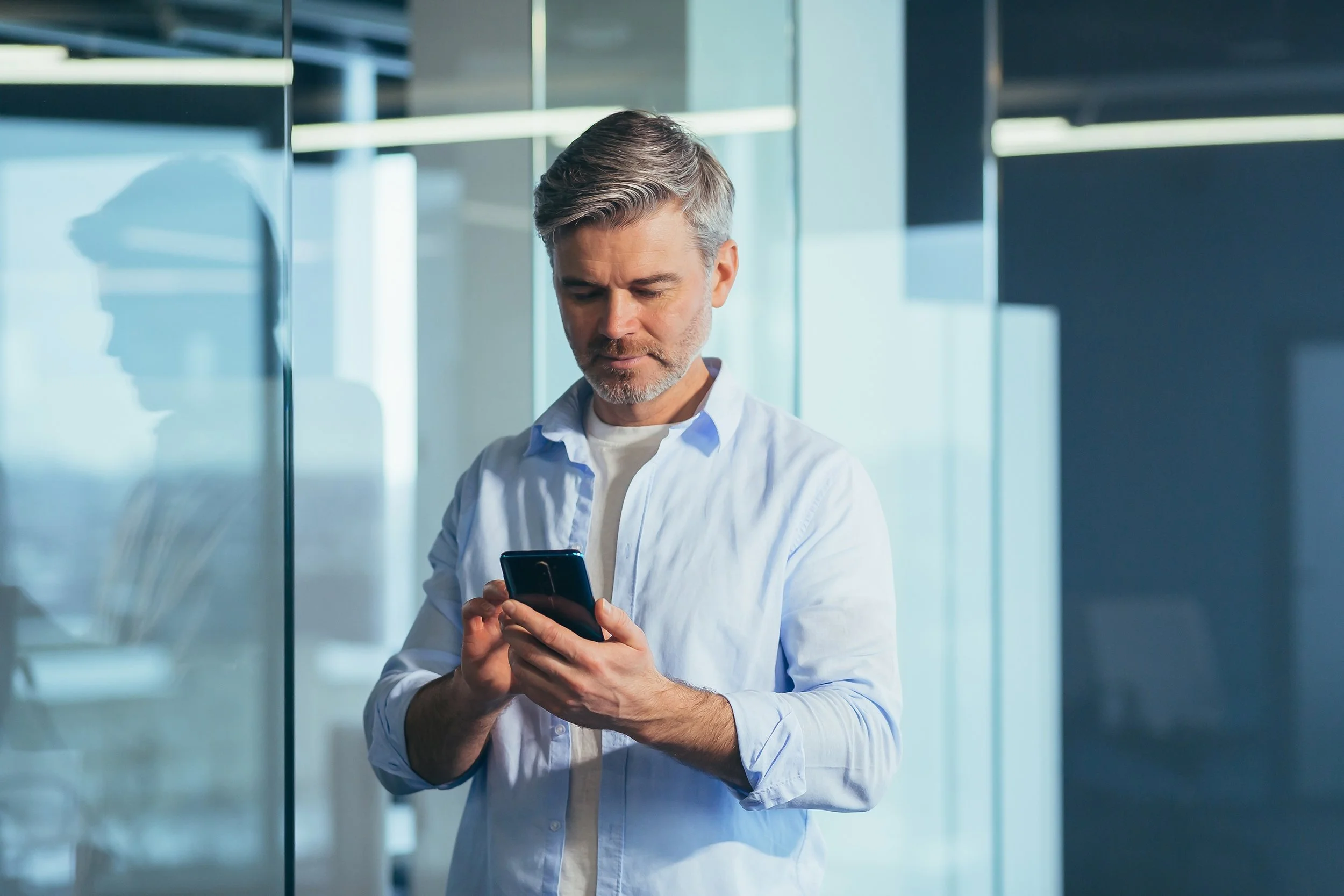 A man looks at his phone. As a Google employee, you can't sell your vested Google Stock Units whenever you want.  Learn more in our complete guide on Google Trading windows.