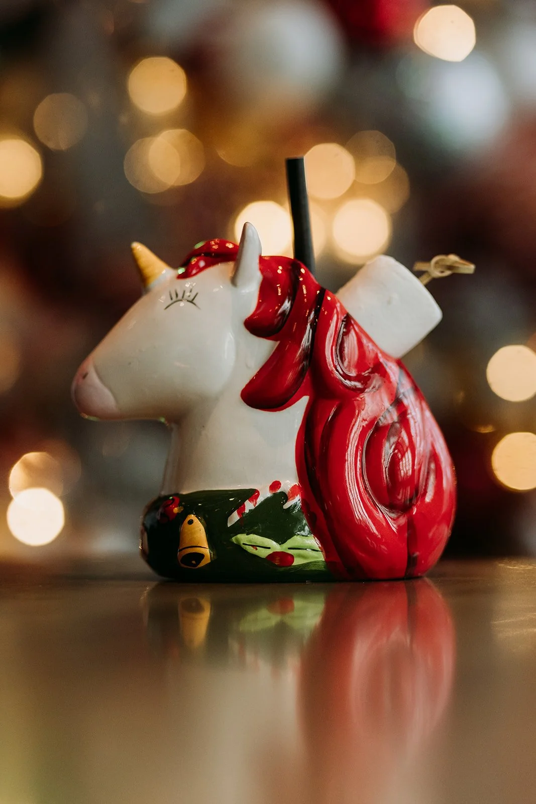 Decorative ceramic unicorn cocktail mug with a red mane, golden horn and marshmallows at Miracle Pop Up Bar at The Raven Room in Whistler BC Canada.
