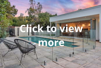 Adelaide renovators turning to modern backyard with a pool, outdoor seating, and a glass fence, adjacent to a contemporary house during sunset.