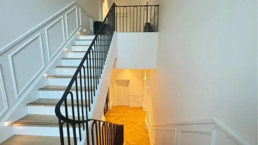 Interior residential painting view of a staircase with white walls, black railing, and wooden steps, leading to an upper level in a luxury home in Gilberton Street Metro Adelaide CBD
