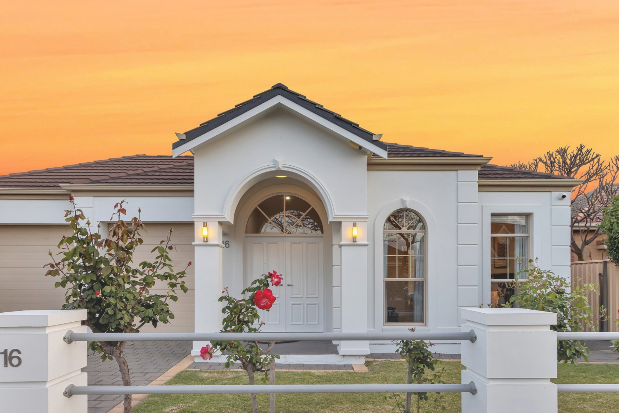 Presale renovation with exterior painting works modern residential  white house with arched doorway, large windows, and a dark tile roof. Near the Athletic Field in Underdale residence, Adelaide South Australia.
