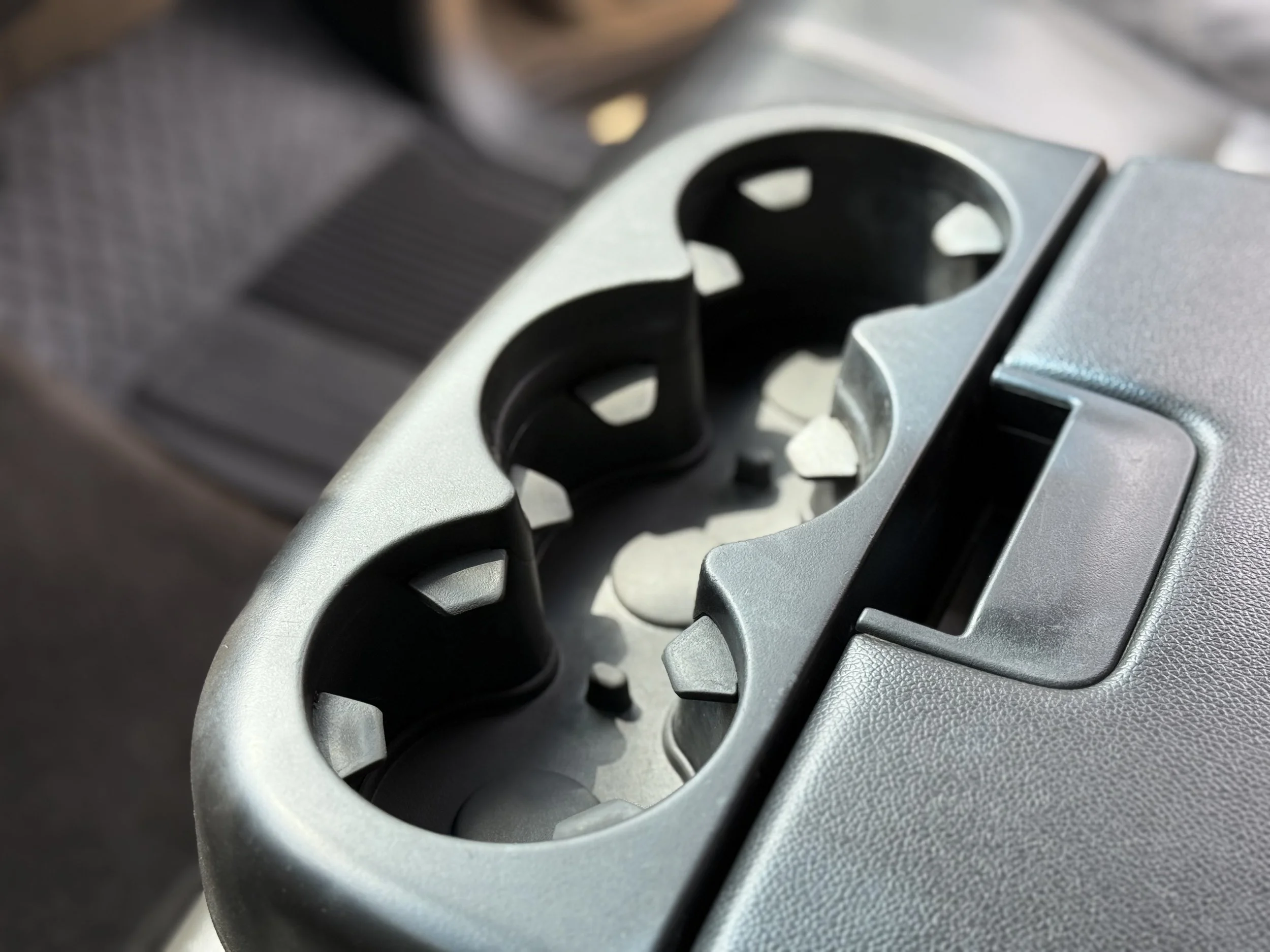 Car cup holder on the vehicle's dashboard.