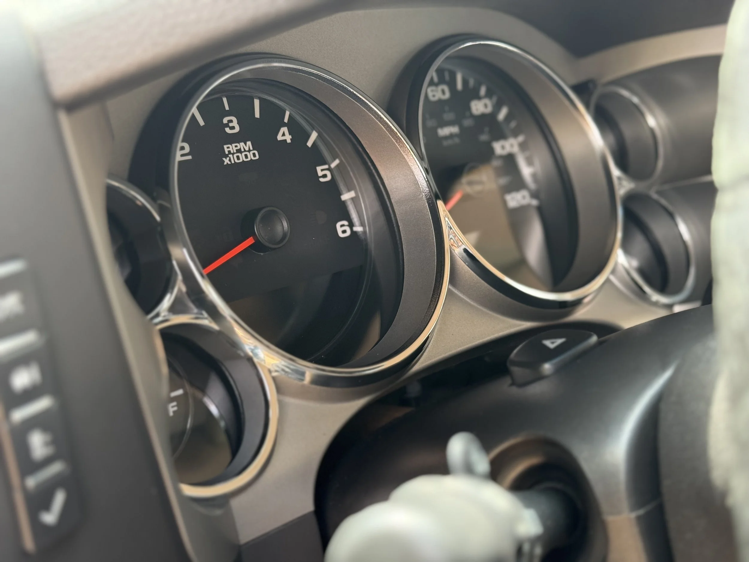 Close-up of a car dashboard showing tachometer, speedometer, and fuel gauge.