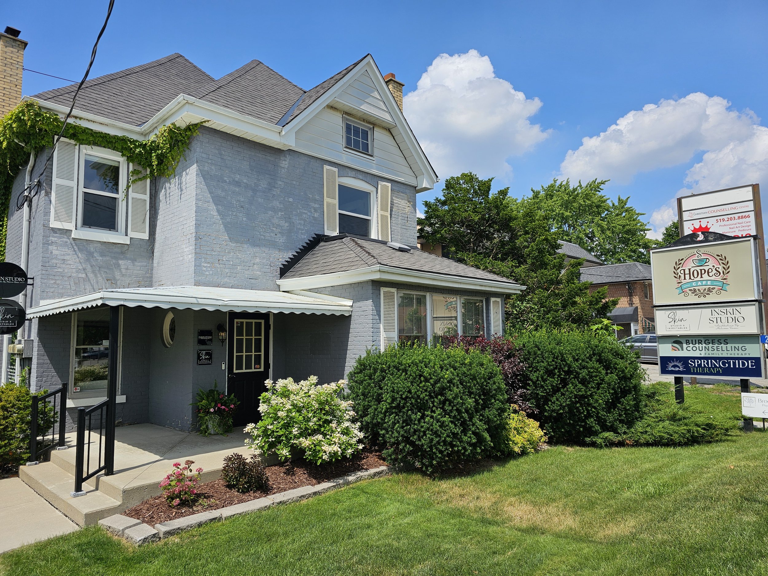 A brick house at 2485 Main Street in Lambeth near London, Ontario. The charming residential building exudes character with its classic blue brick exterior, embodying a sense of warmth and tradition.