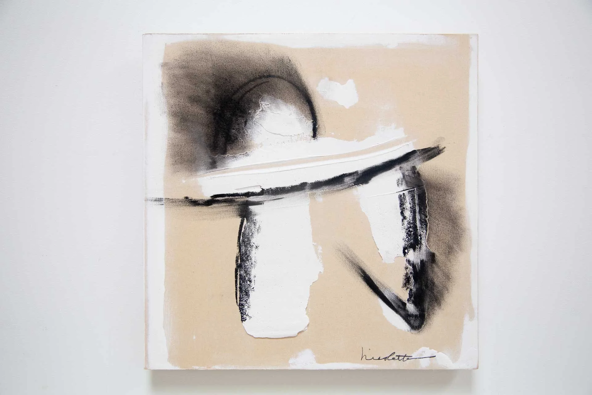 Abstract monochrome painting with black brushstrokes and beige background.