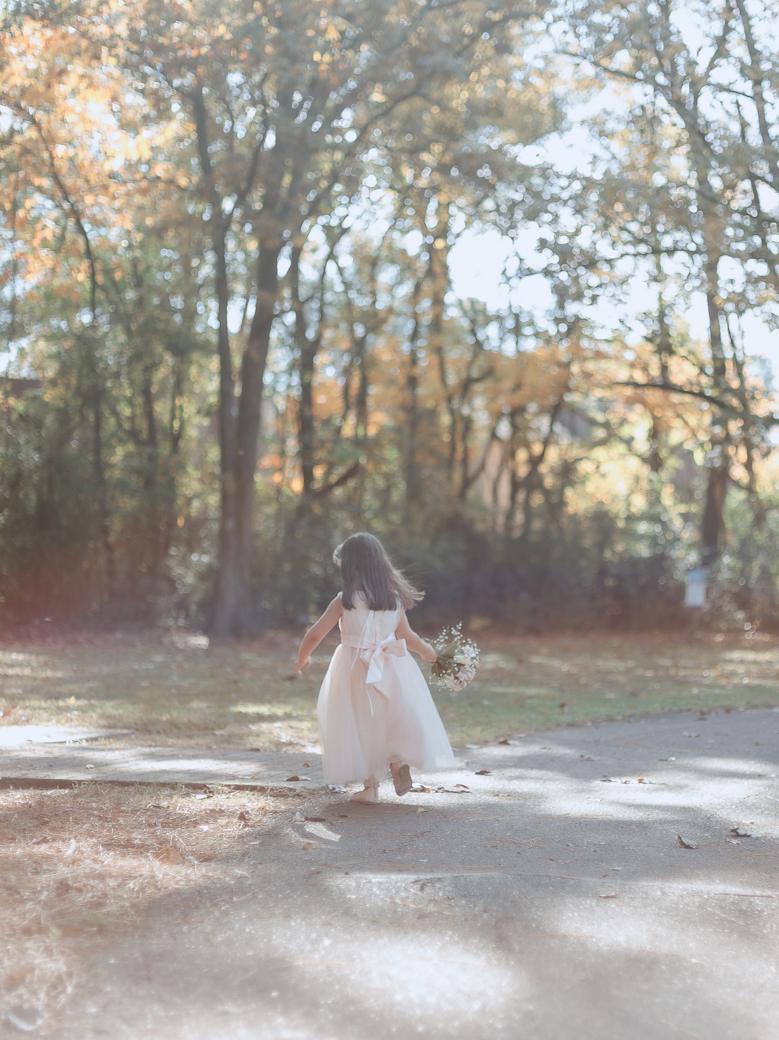 little girl running away from the camera
