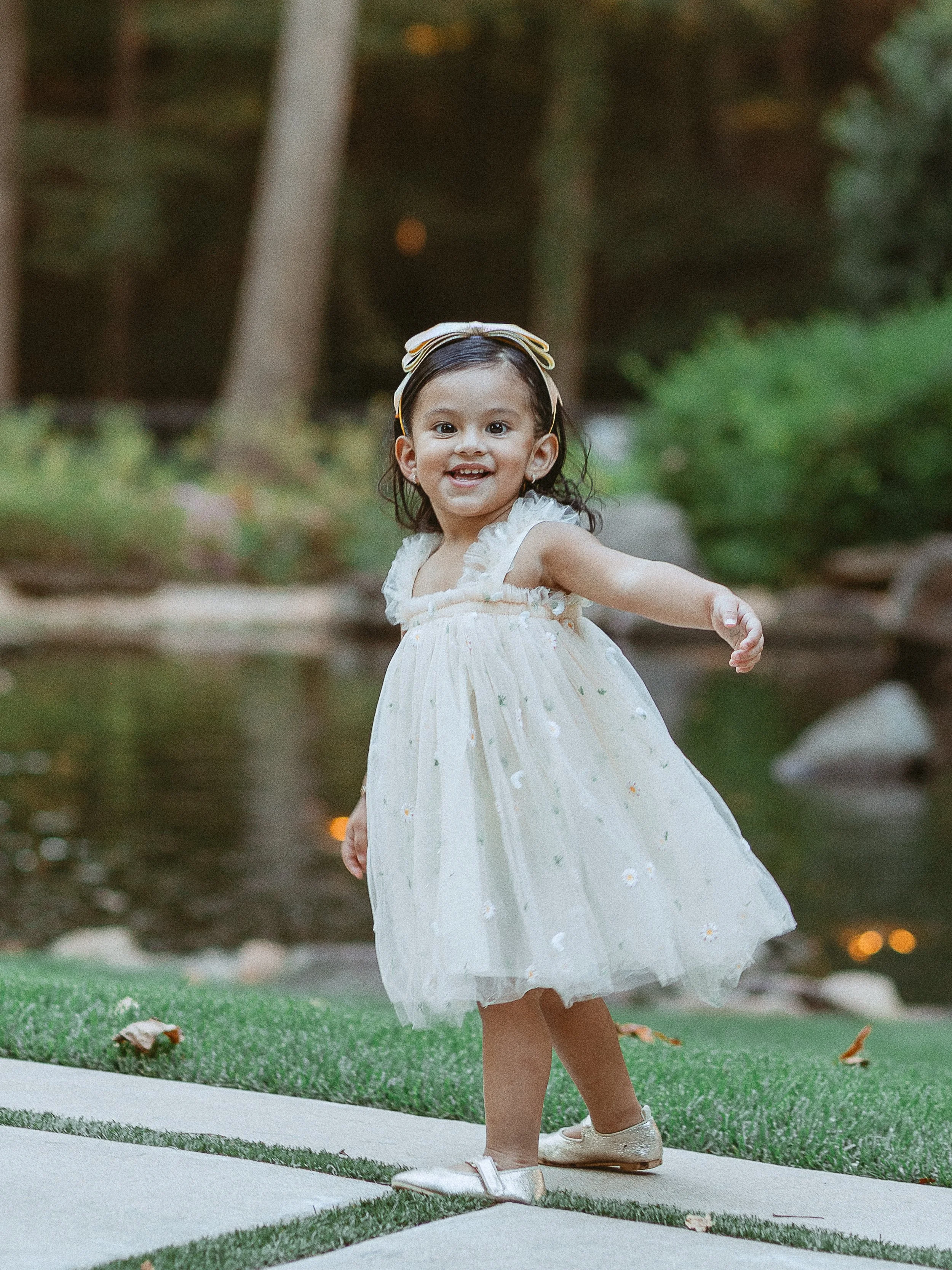Candid photo of smiling 2 year old running during child portrait session.