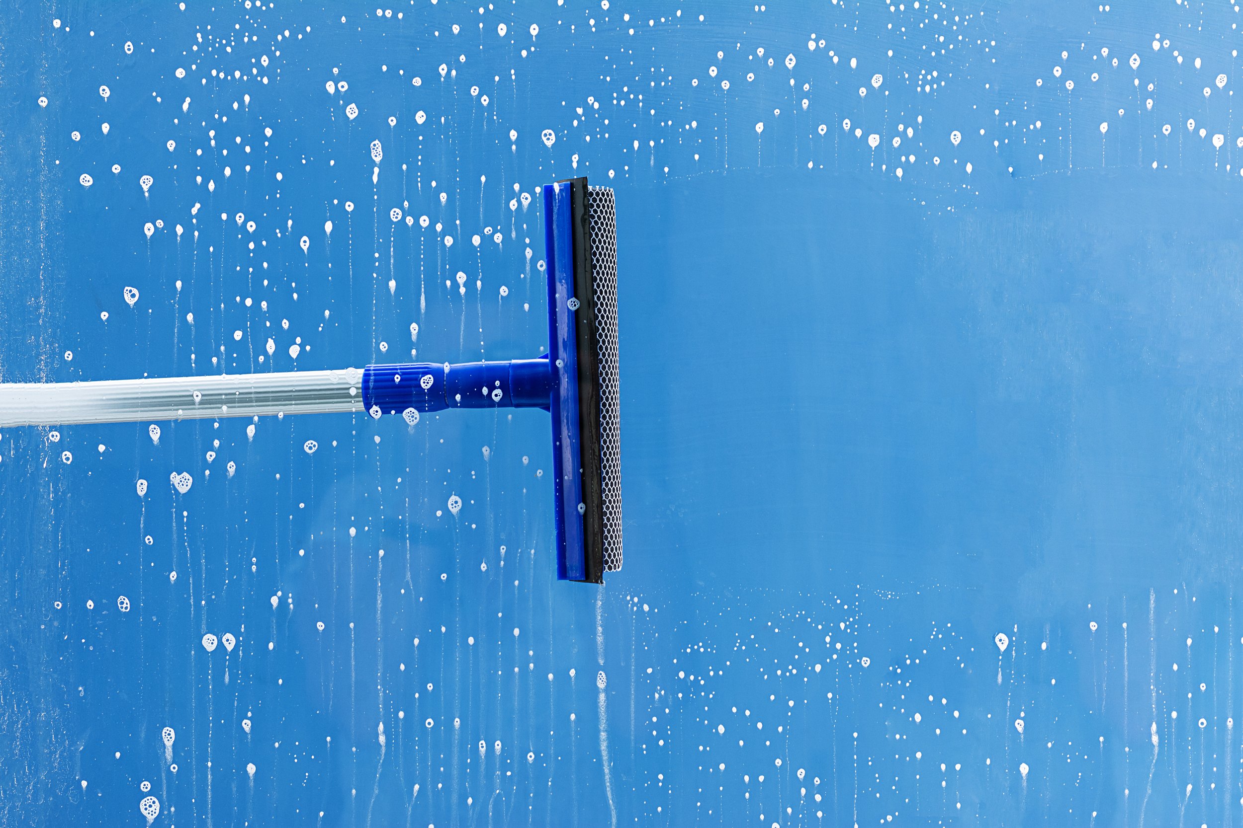 rubber-squeegee-cleans-window-clears-stripe-soaped-window-cleaning-service-concept.jpg